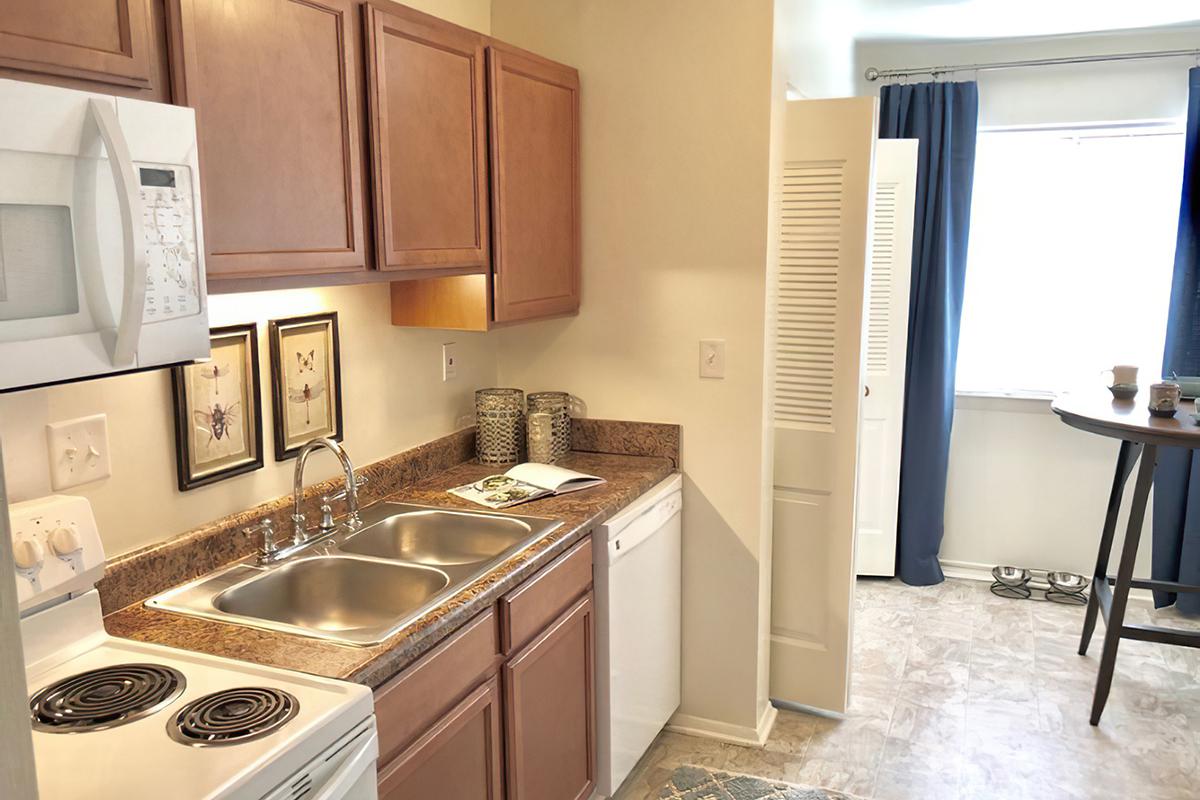 a kitchen with a stove a sink and a microwave