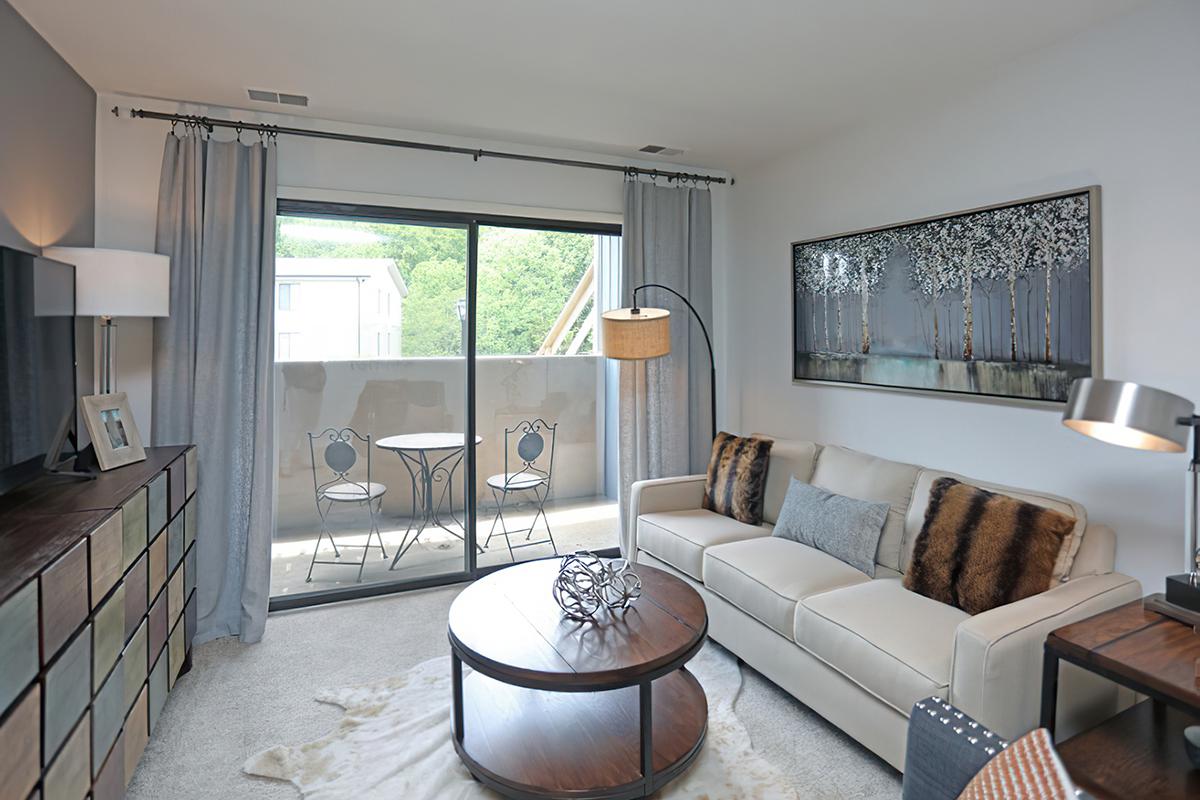 a living room filled with furniture and a large window