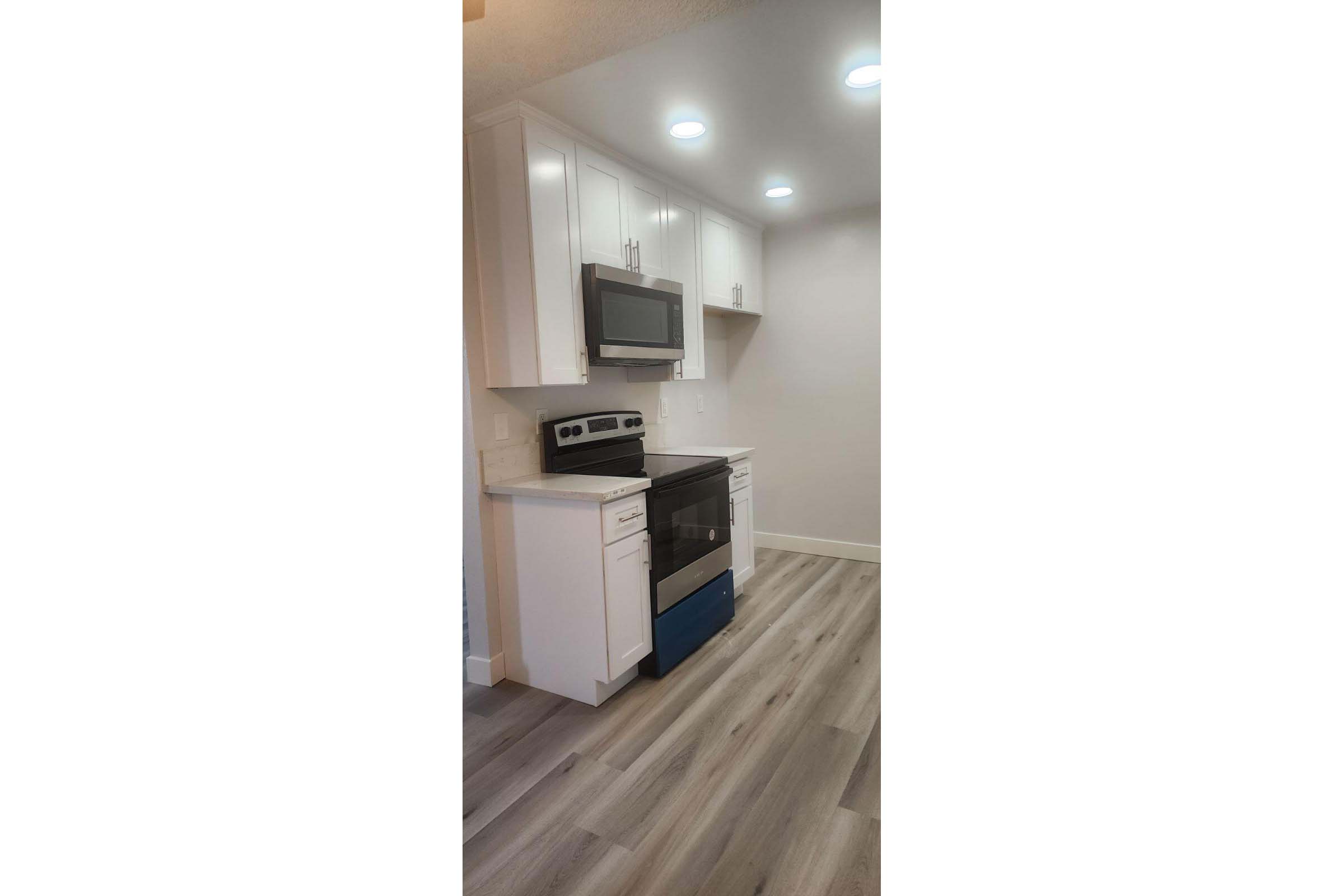 a kitchen with wooden cabinets