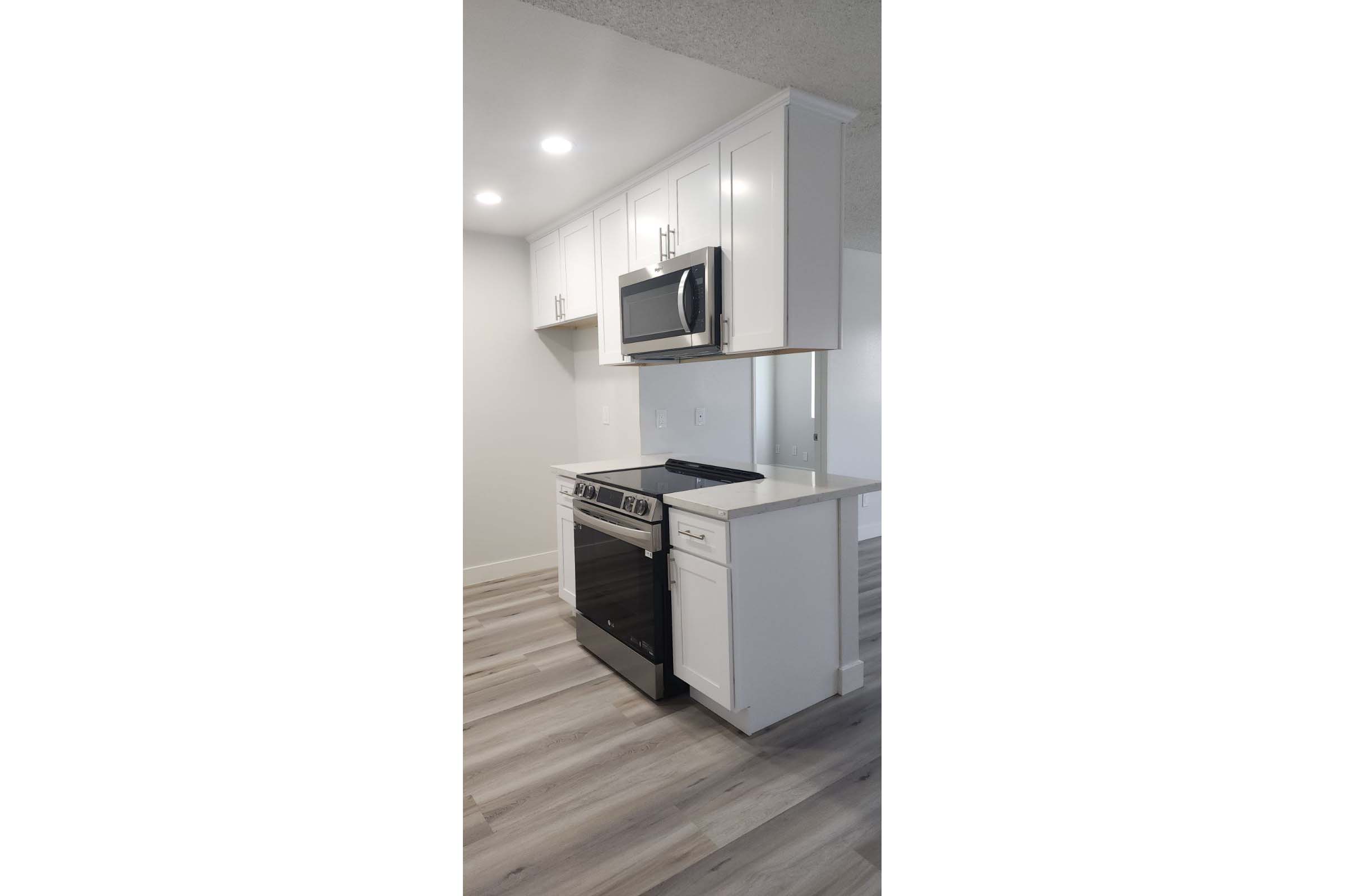 a kitchen with a stove and a refrigerator