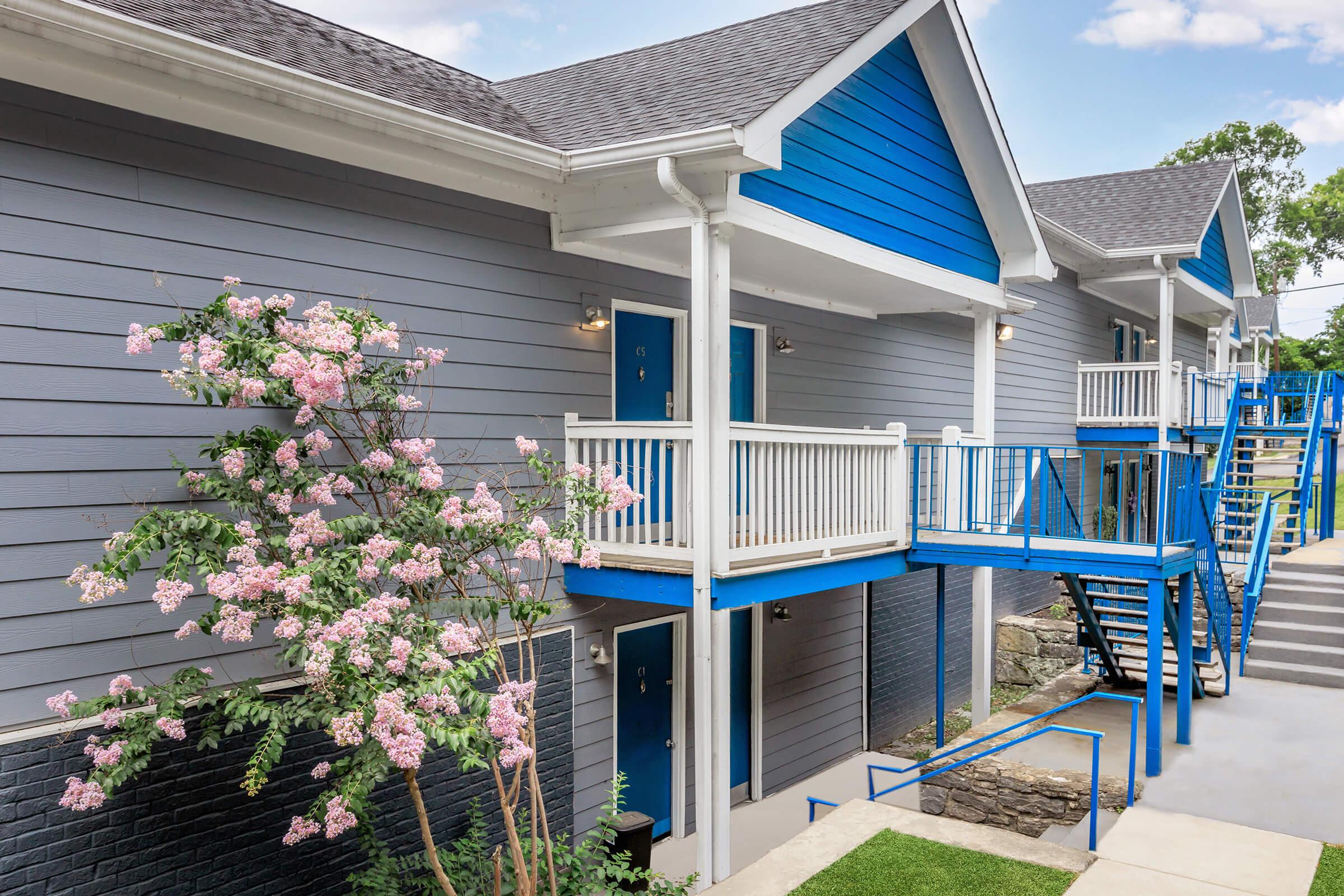 a blue bench in front of a house