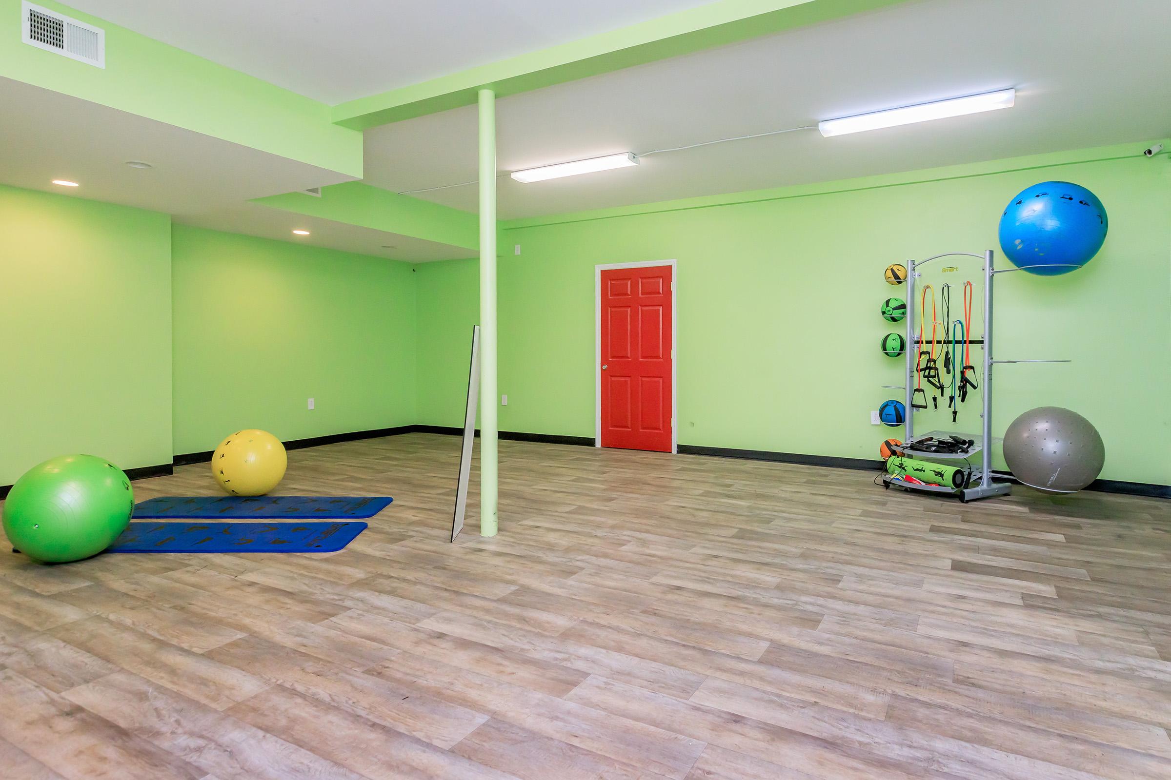 a green ball on a wooden floor