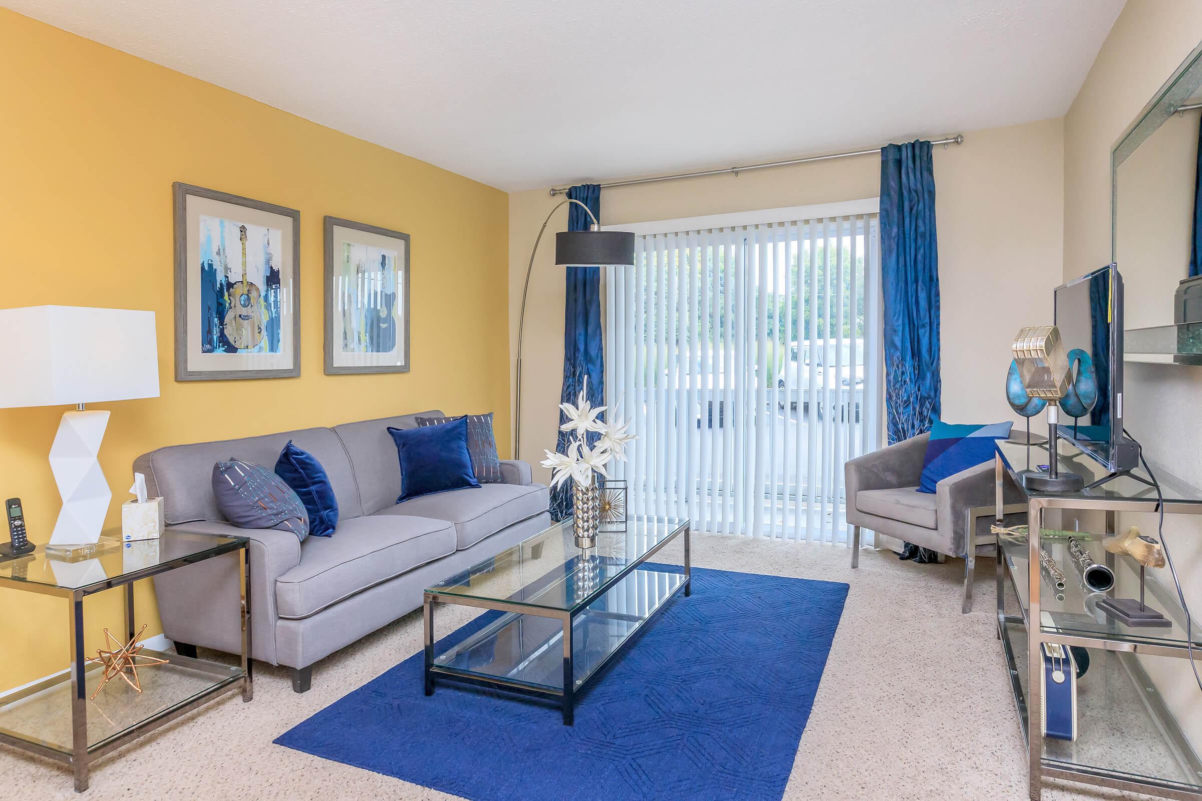 a living room filled with furniture and a large window