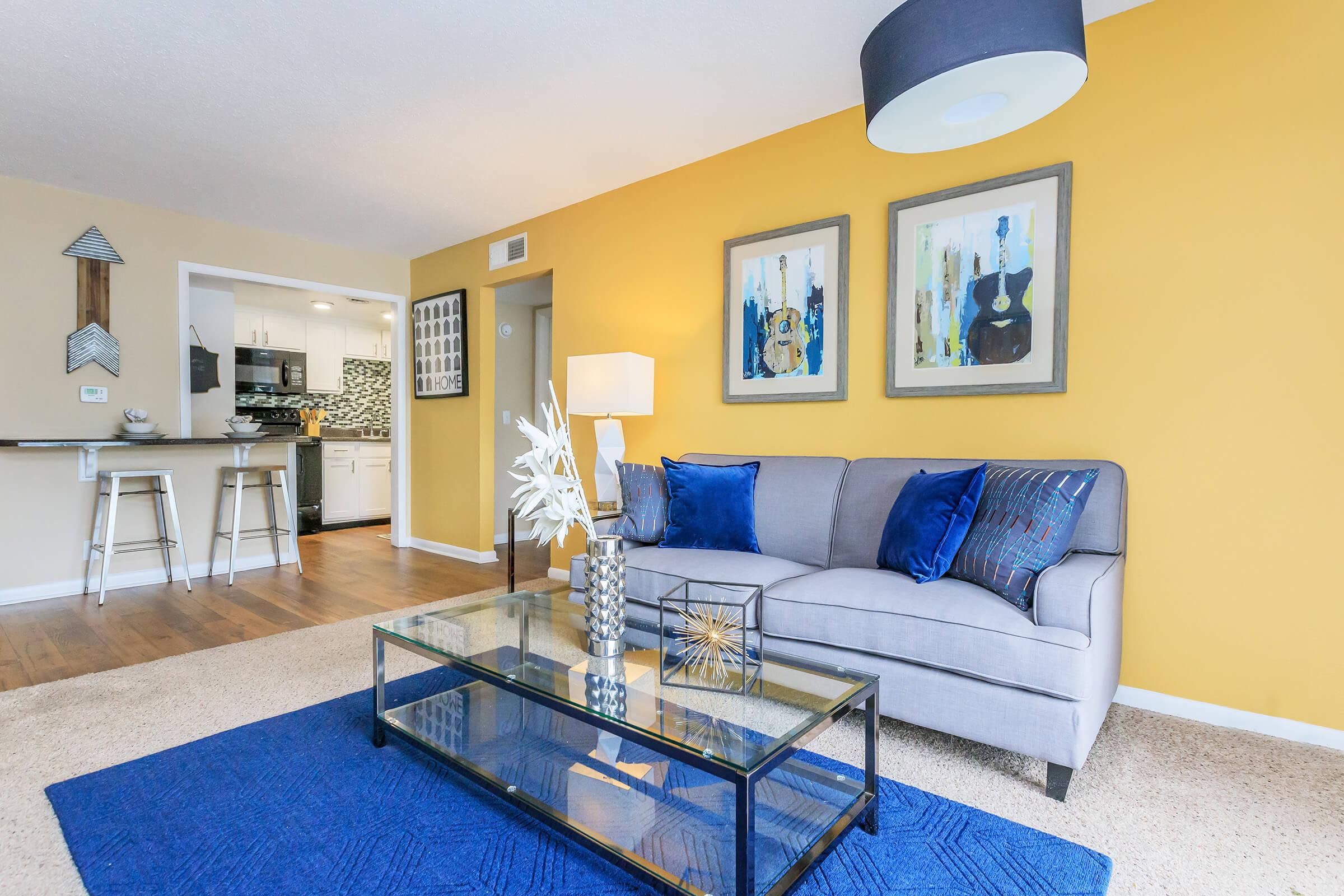 a living room with blue furniture