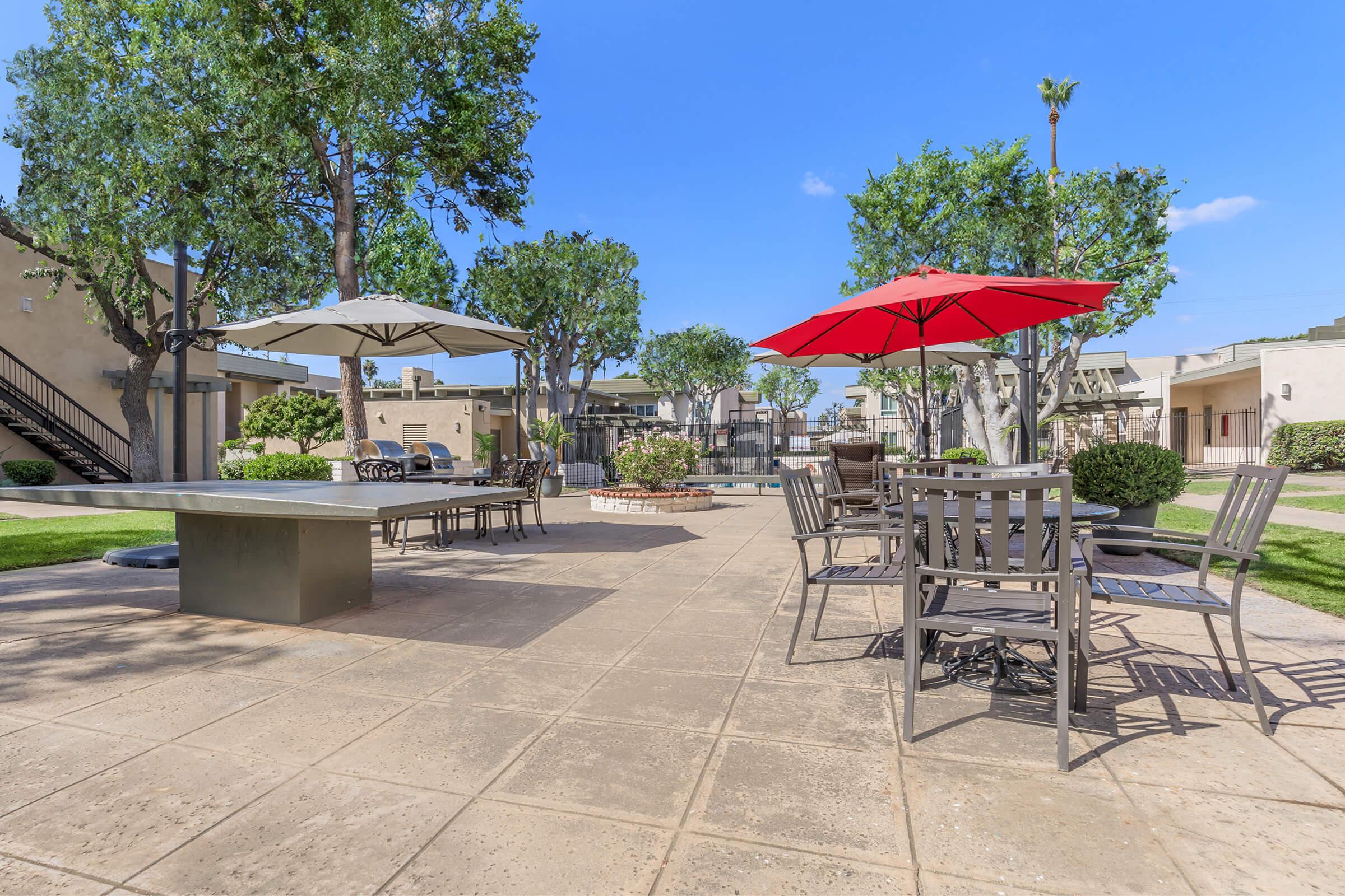 a group of lawn chairs sitting under an umbrella