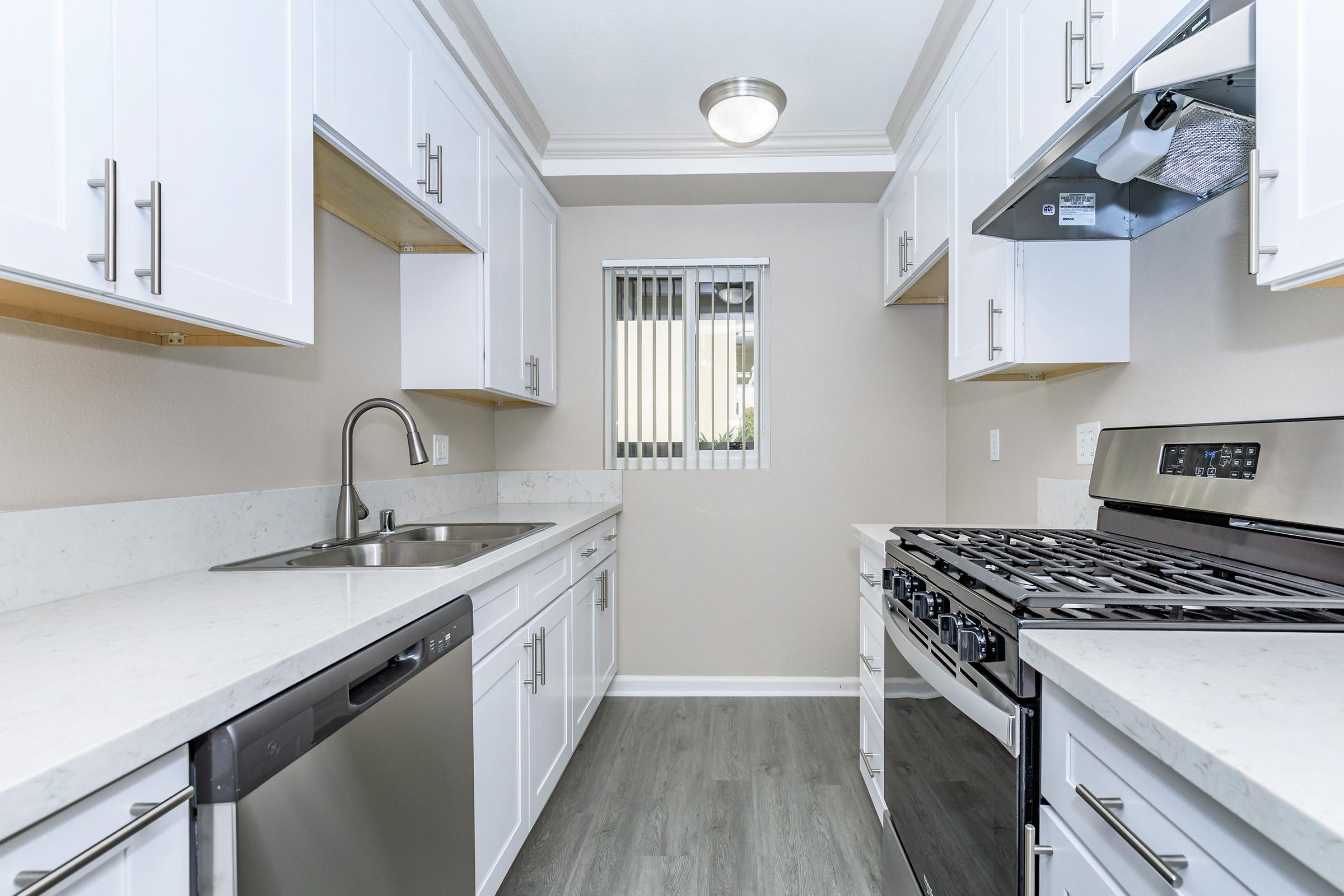 a kitchen with a stove and a sink