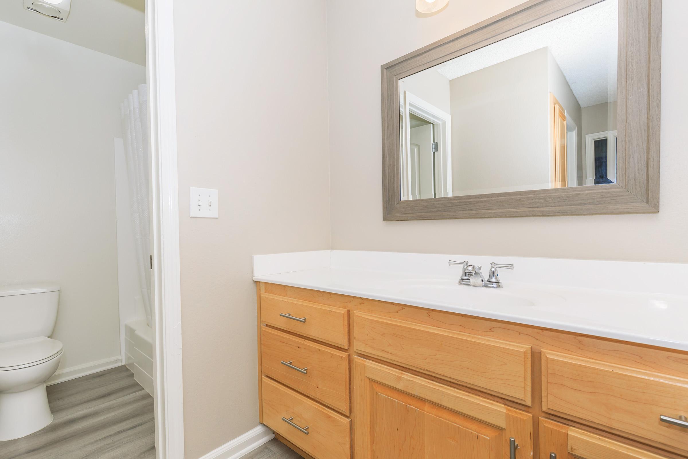 a kitchen with a sink and a mirror