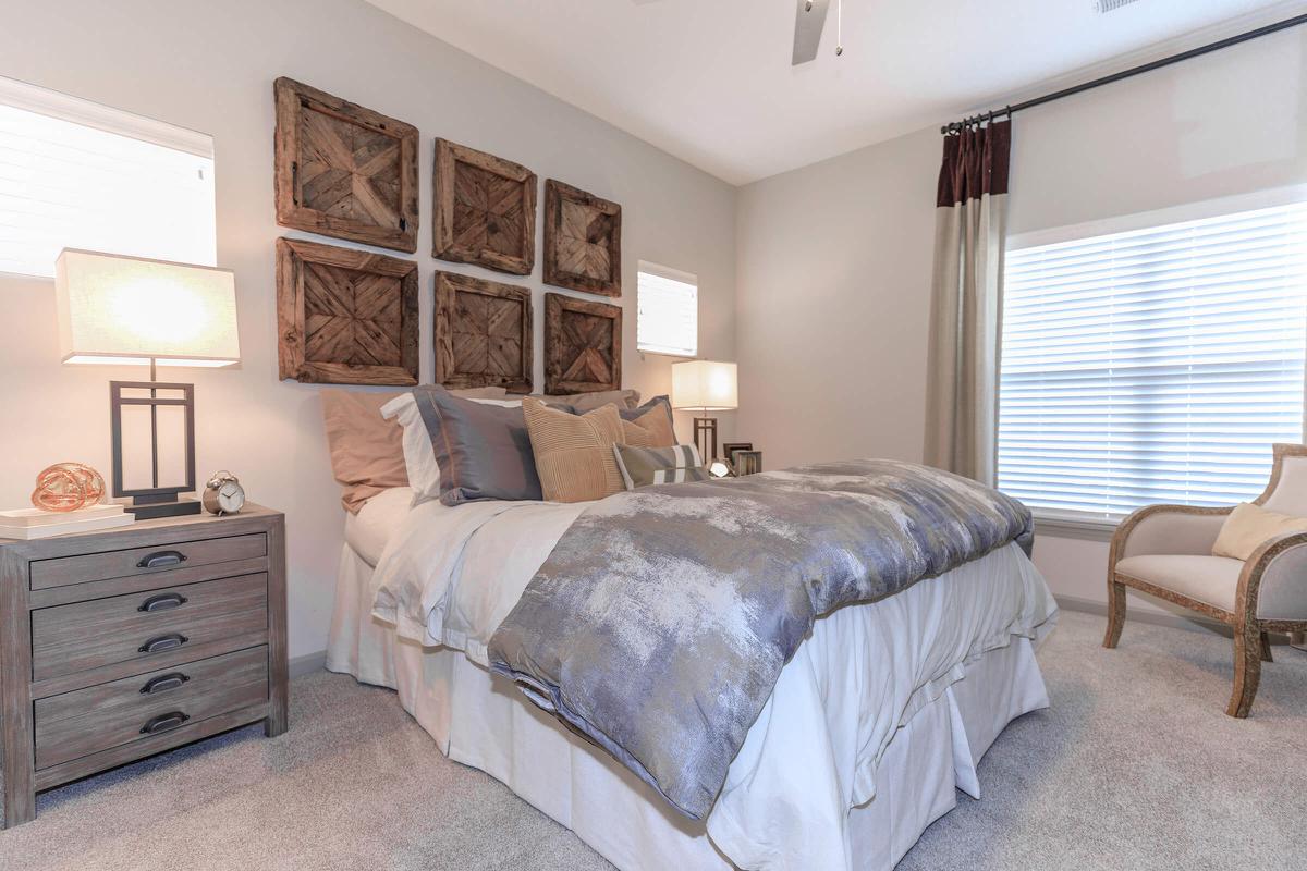 a bedroom with a bed and desk in a room