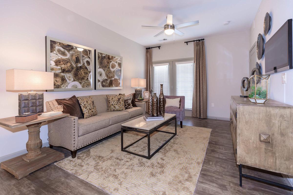a living room filled with furniture and a large window
