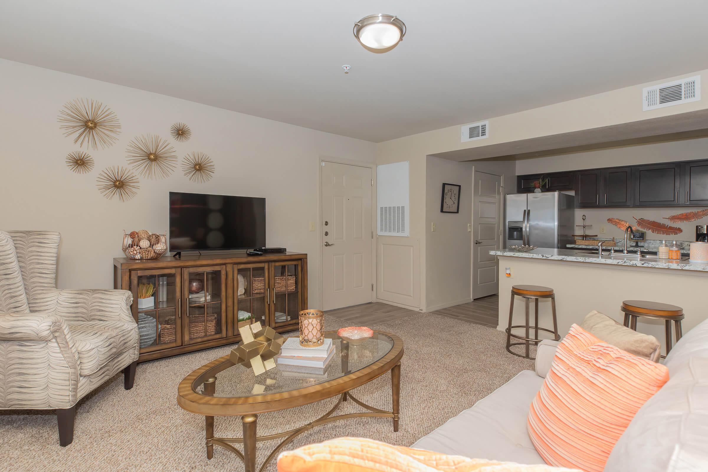 a living room filled with furniture and a bed