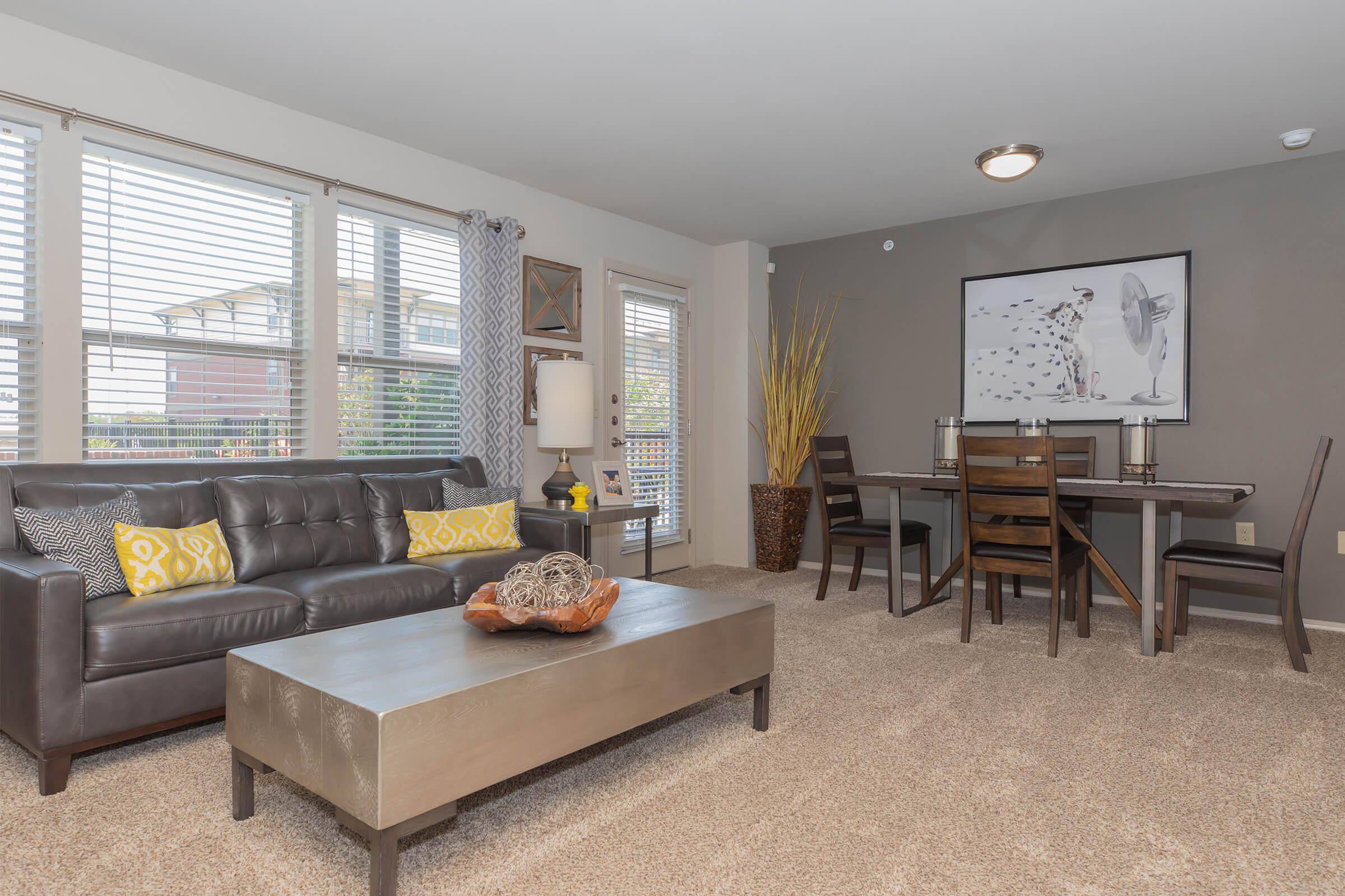 a living room filled with furniture and a large window