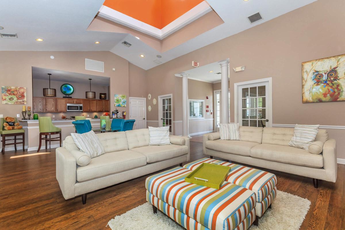 a living room filled with furniture and a flat screen tv