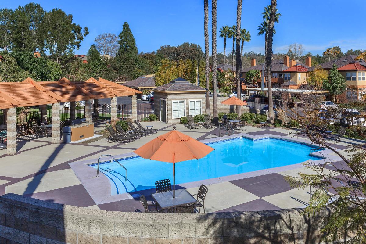 a group of lawn chairs sitting next to a pool