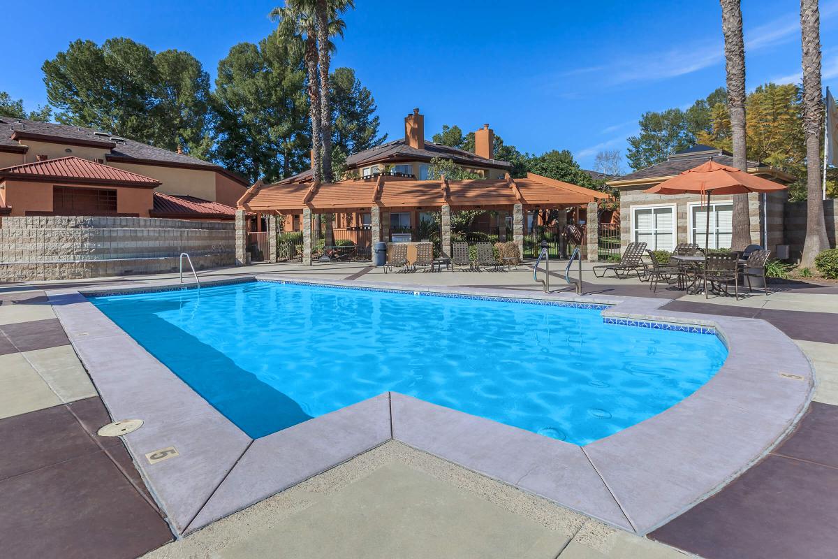 a house with a pool outside of a building