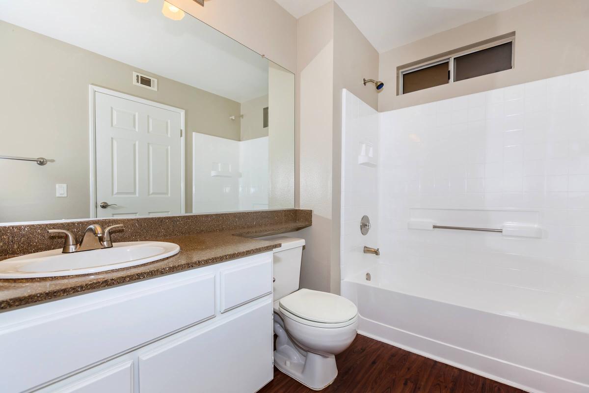 a white sink sitting next to a shower