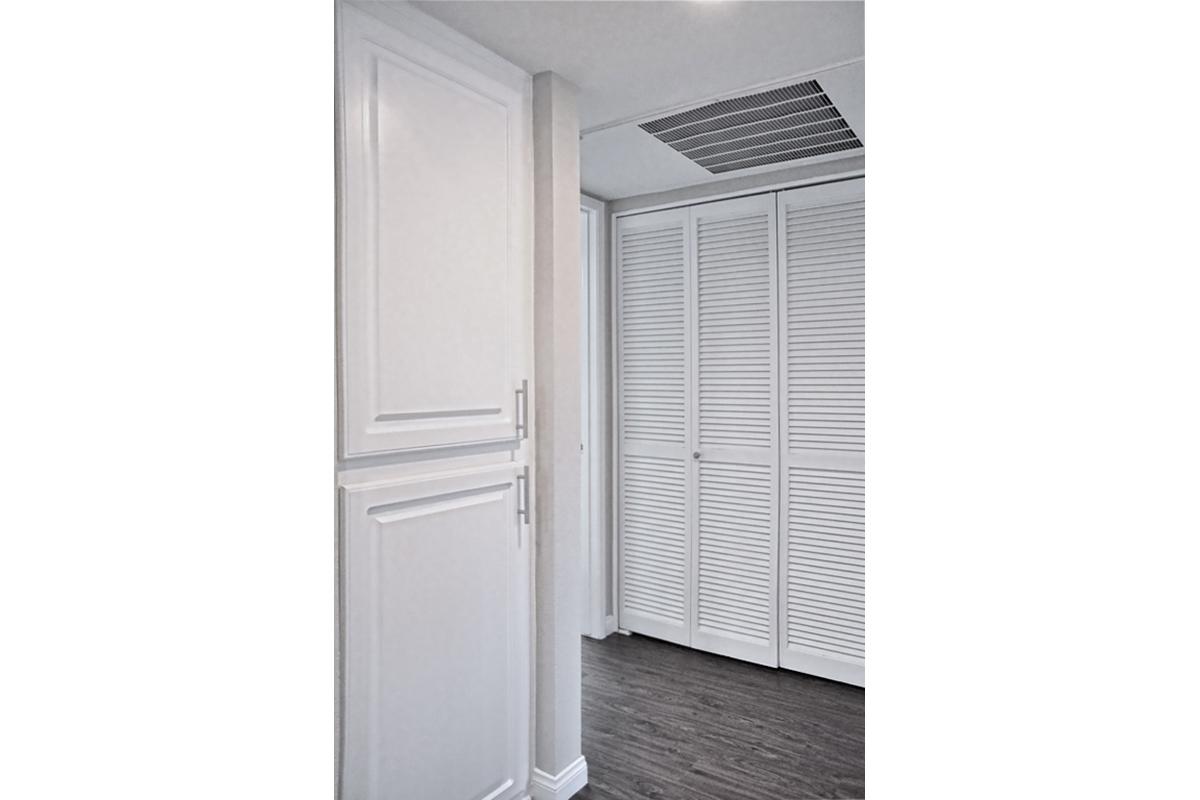 a white refrigerator freezer sitting next to a door