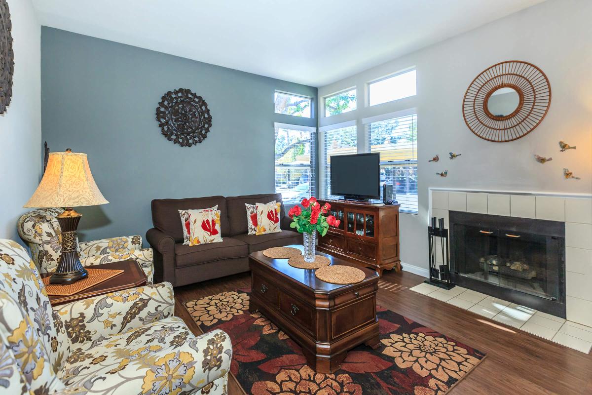 a living room filled with furniture and a fire place