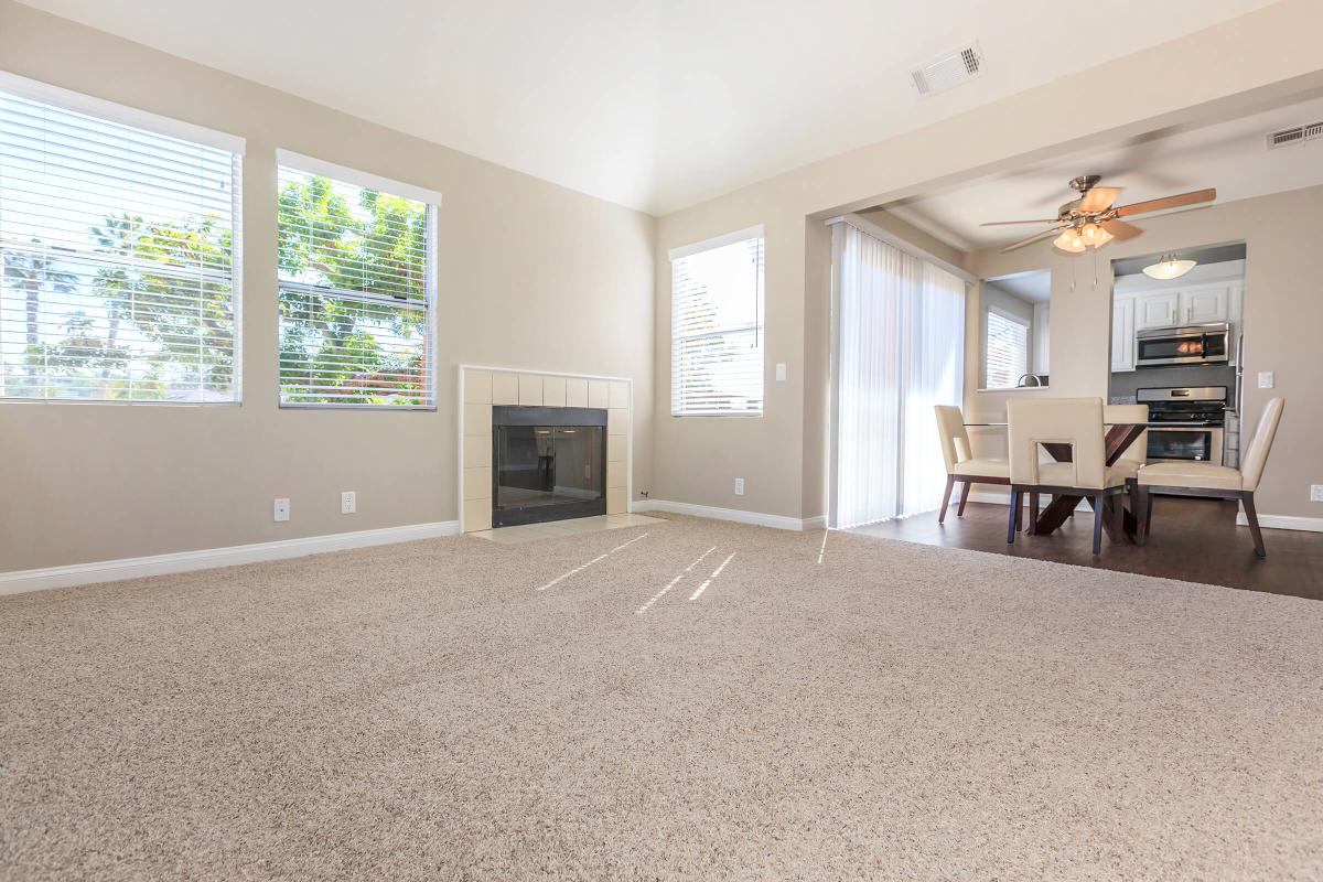 a living room filled with furniture and a large window