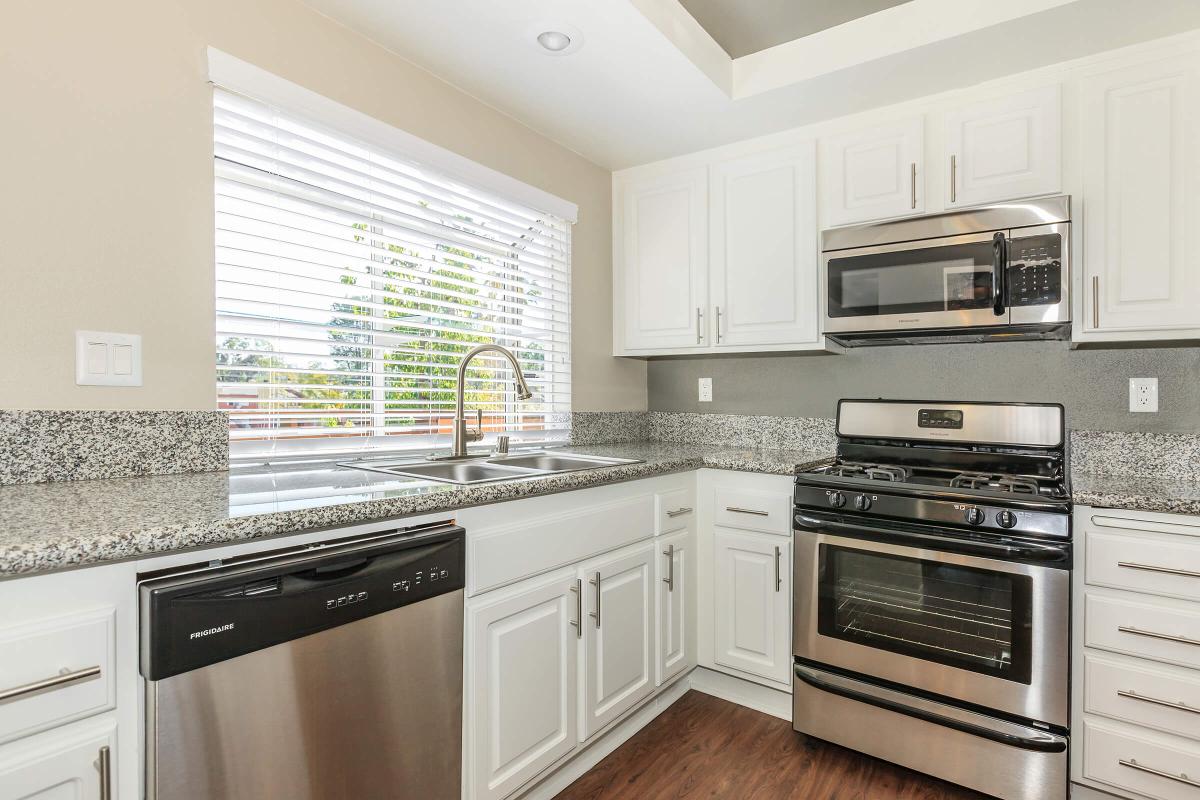 a kitchen with stainless steel appliances and wooden cabinets