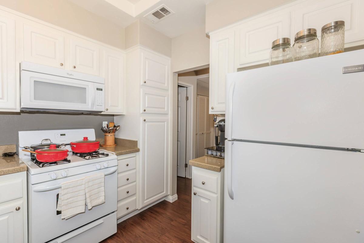 a white refrigerator freezer sitting inside of a kitchen