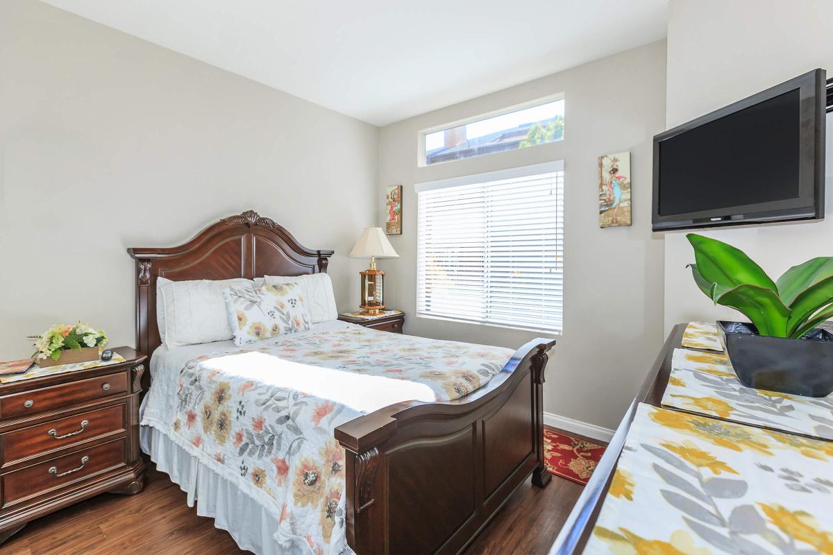 a bedroom with a bed and desk in a room