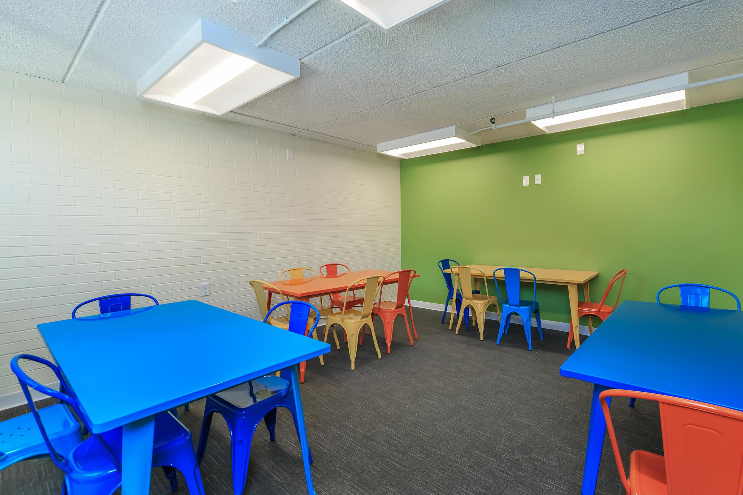 Linwood Square community room with blue tables and chairs