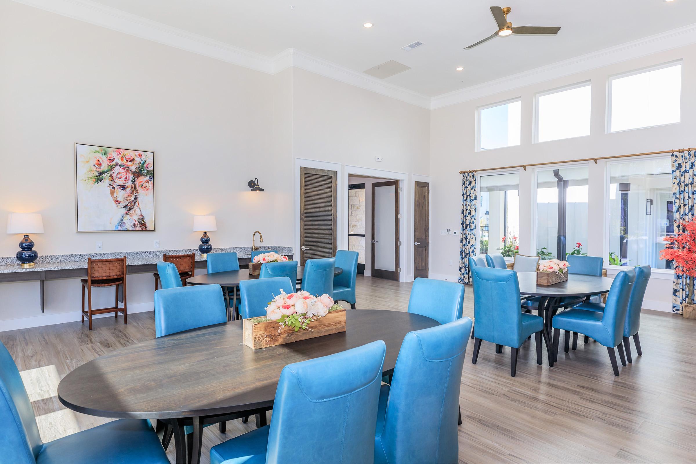 a living room filled with furniture and a blue chair