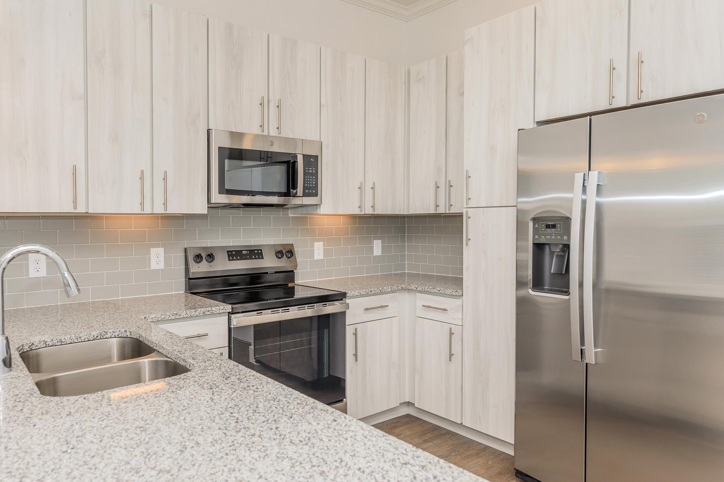 a modern kitchen with stainless steel appliances