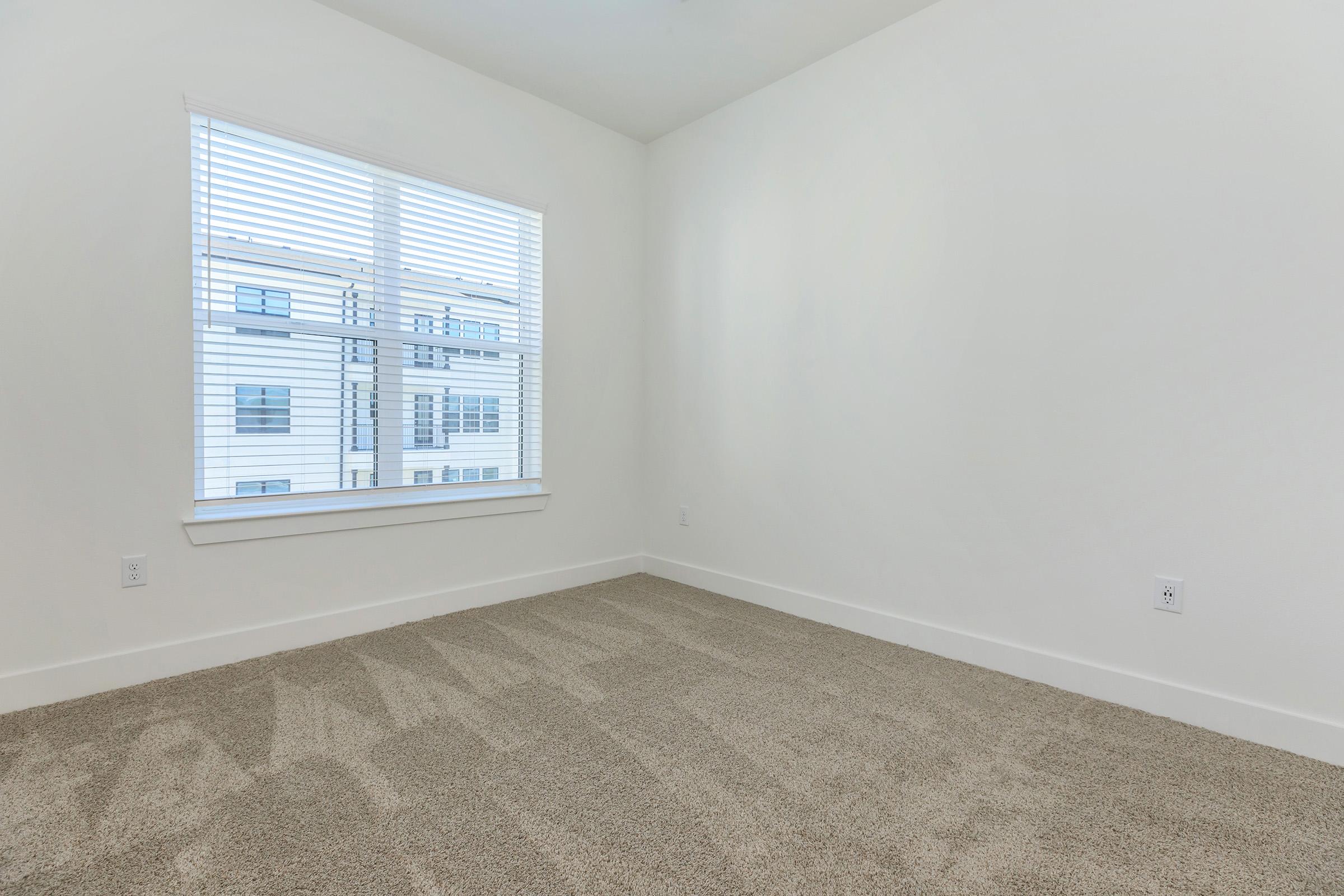 a bedroom with a large window