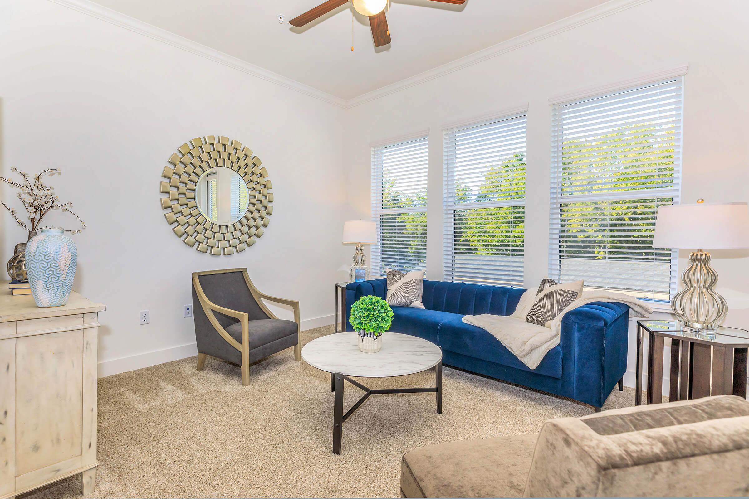 a living room filled with furniture and a large window