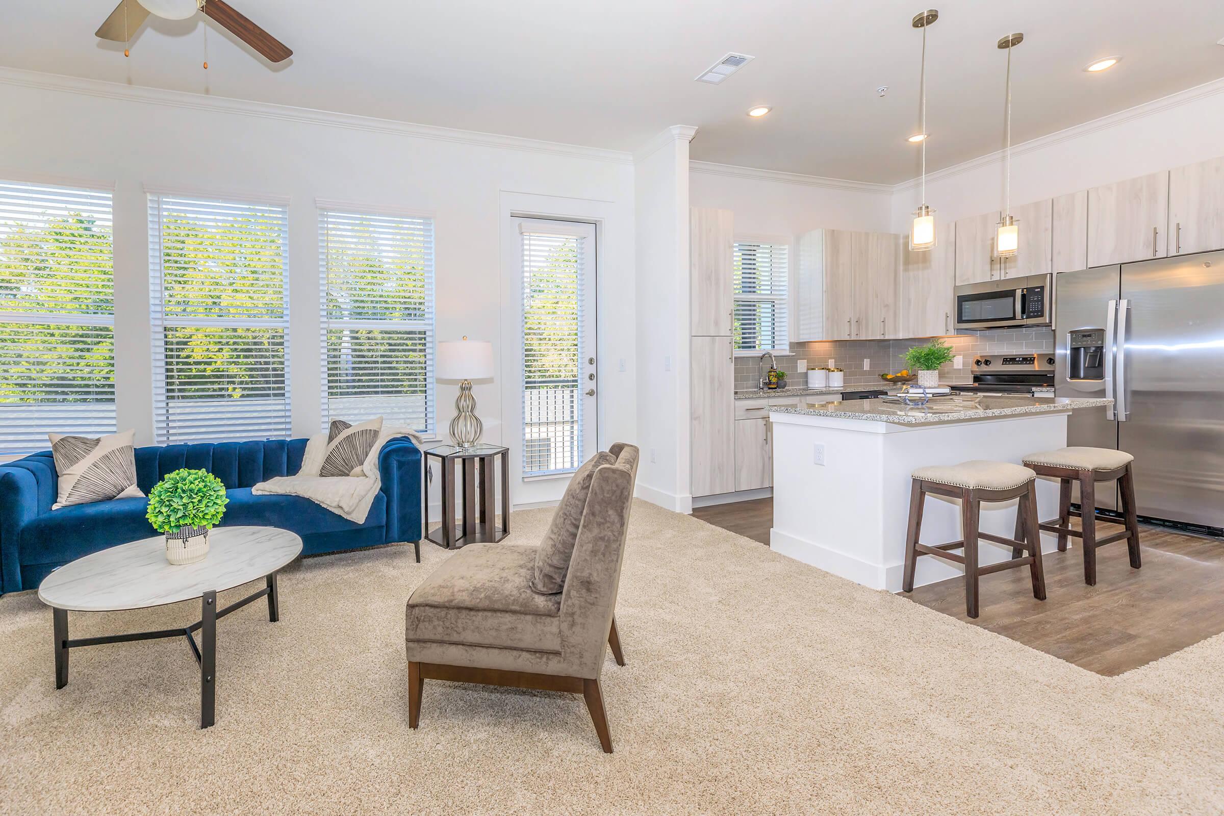 a living room filled with furniture and a large window