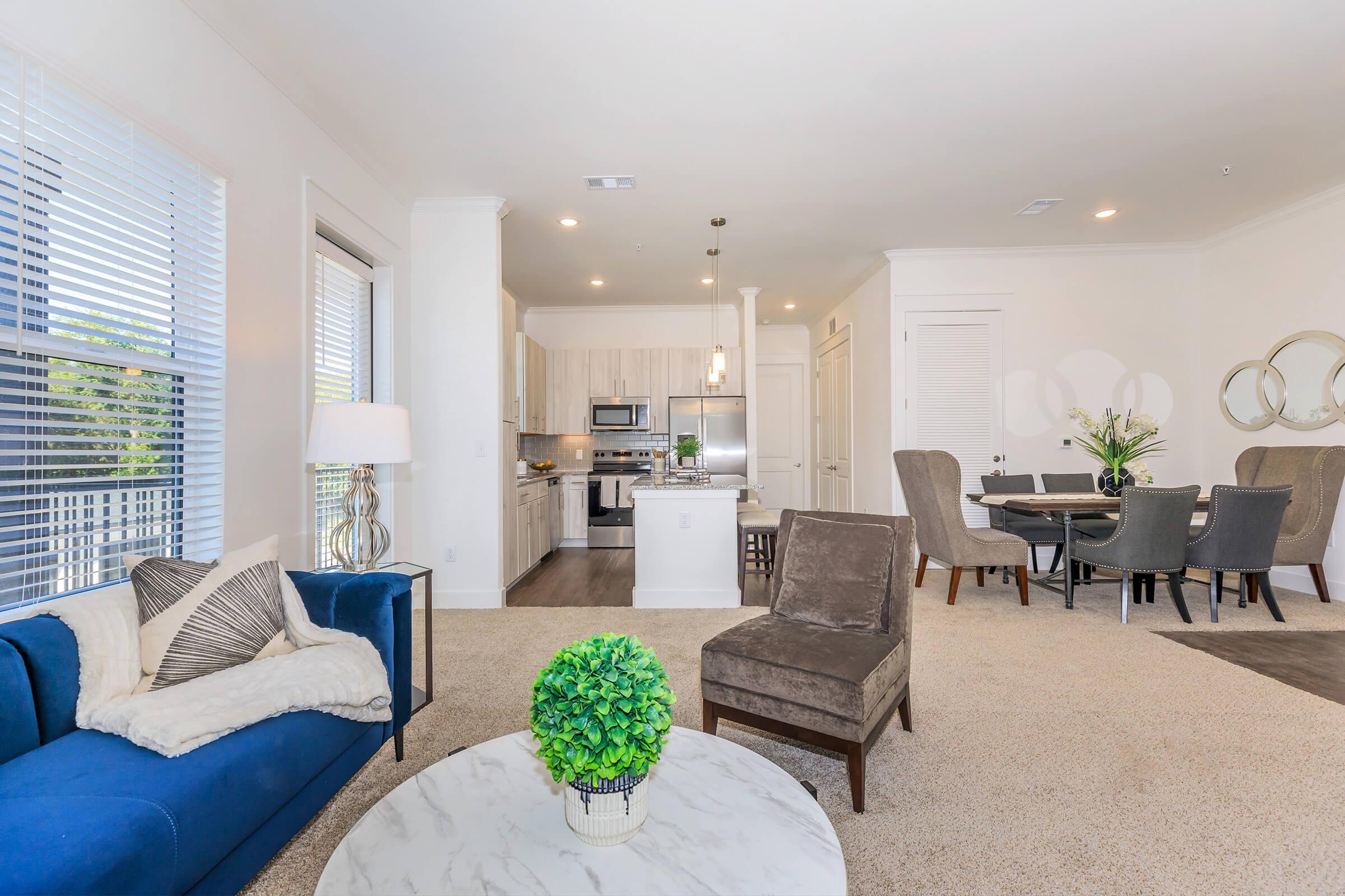 a living room filled with furniture and a large window