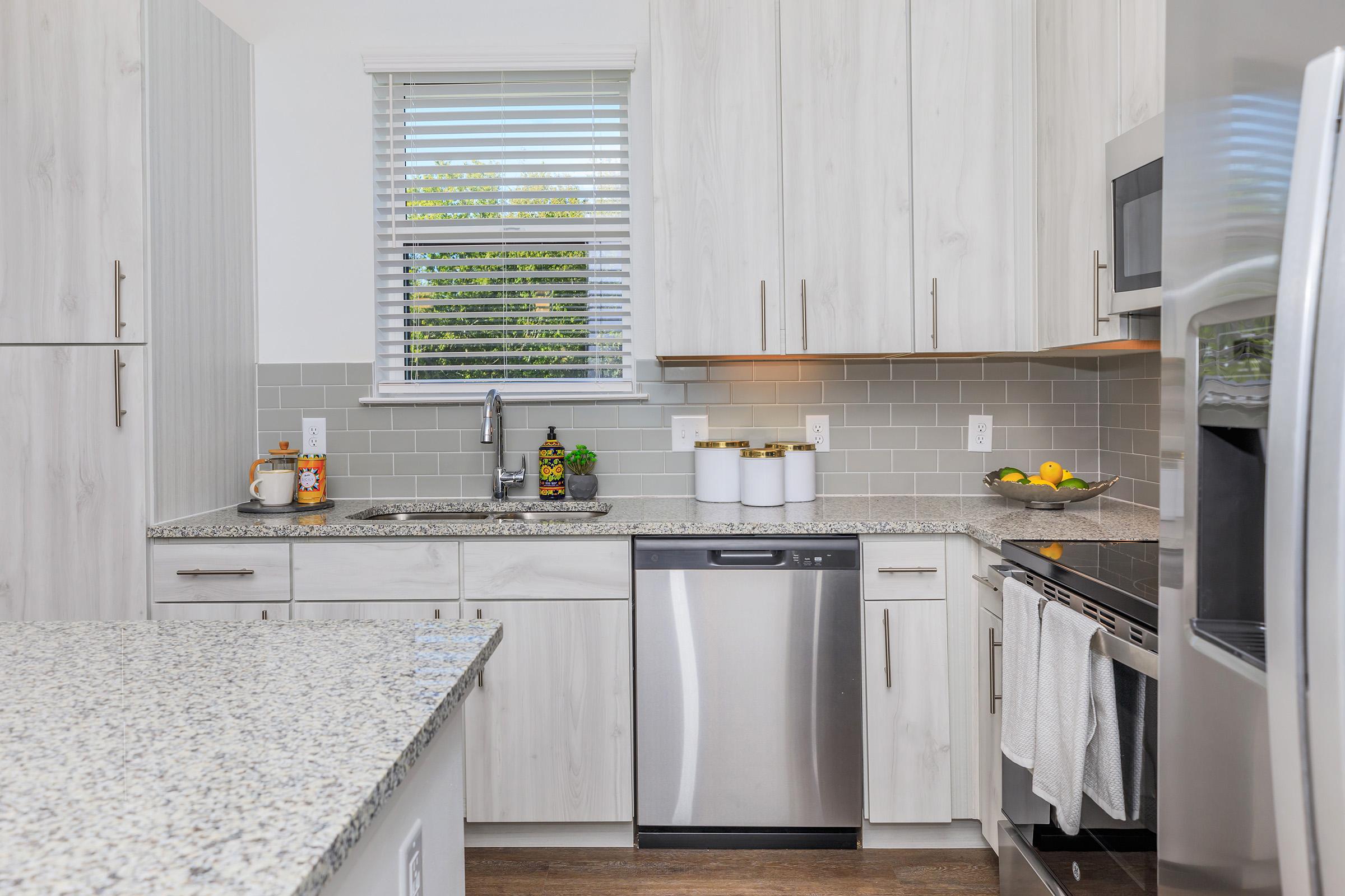 a large kitchen with stainless steel appliances