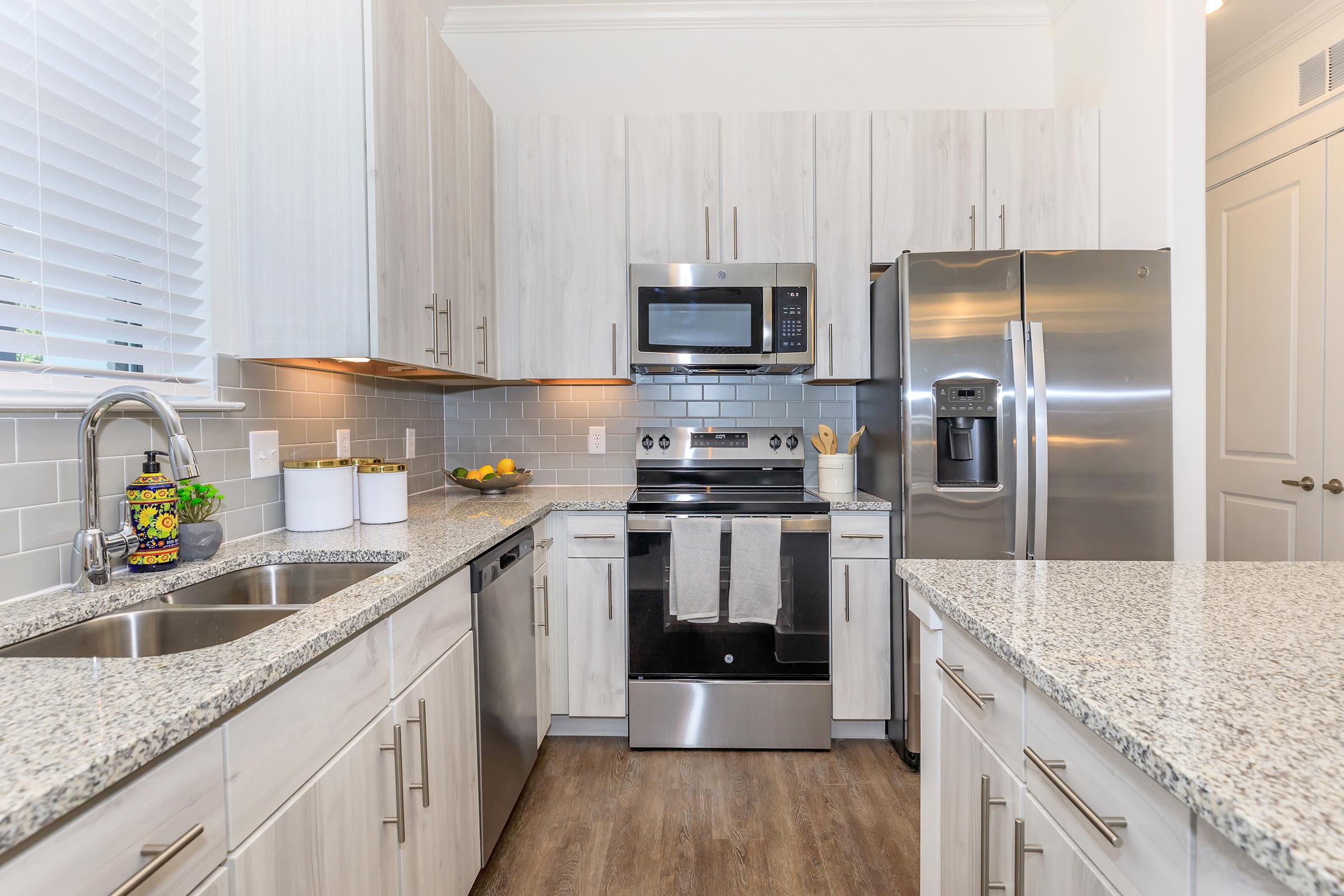 a large kitchen with stainless steel appliances