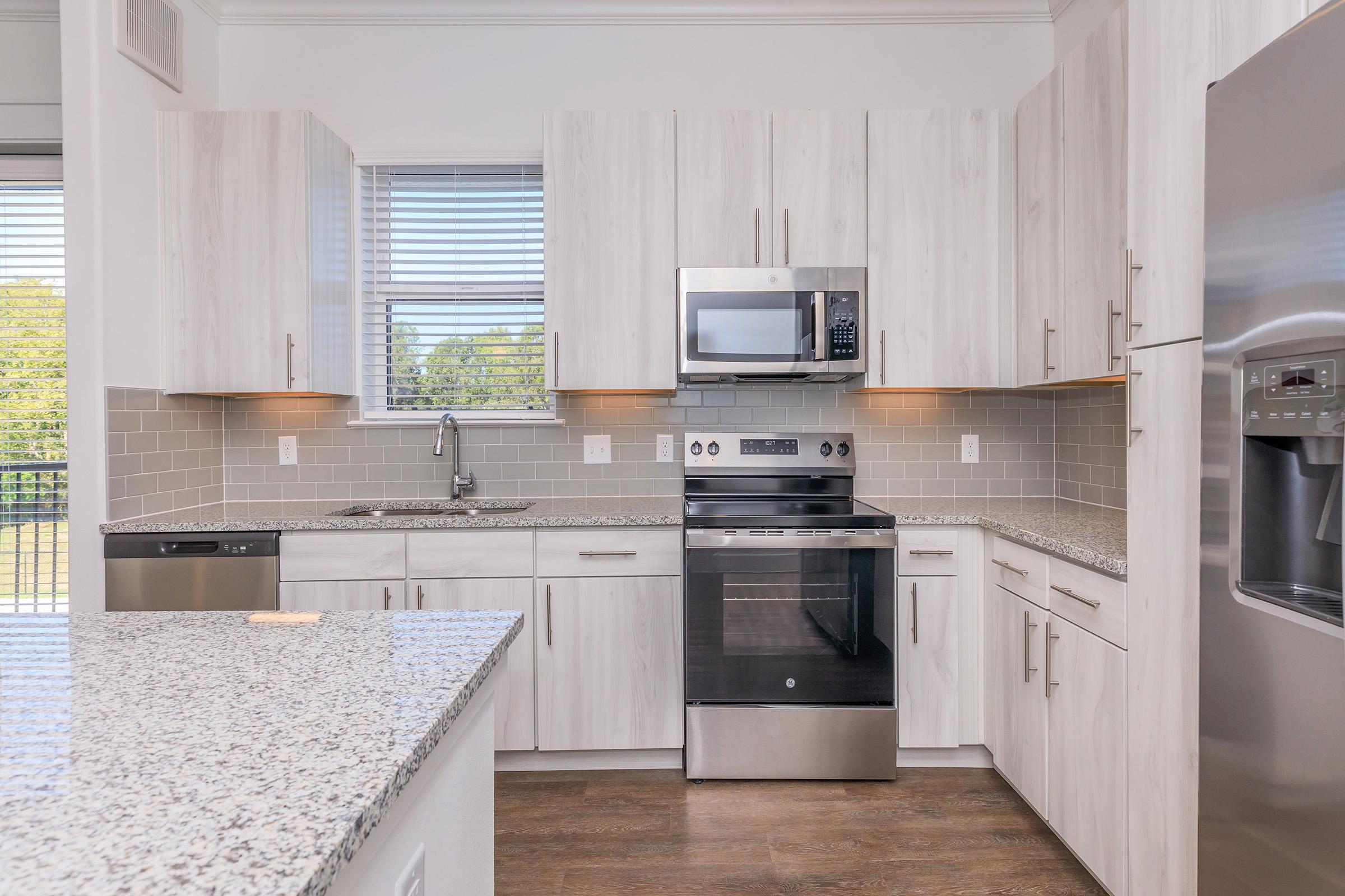 a large kitchen with stainless steel appliances