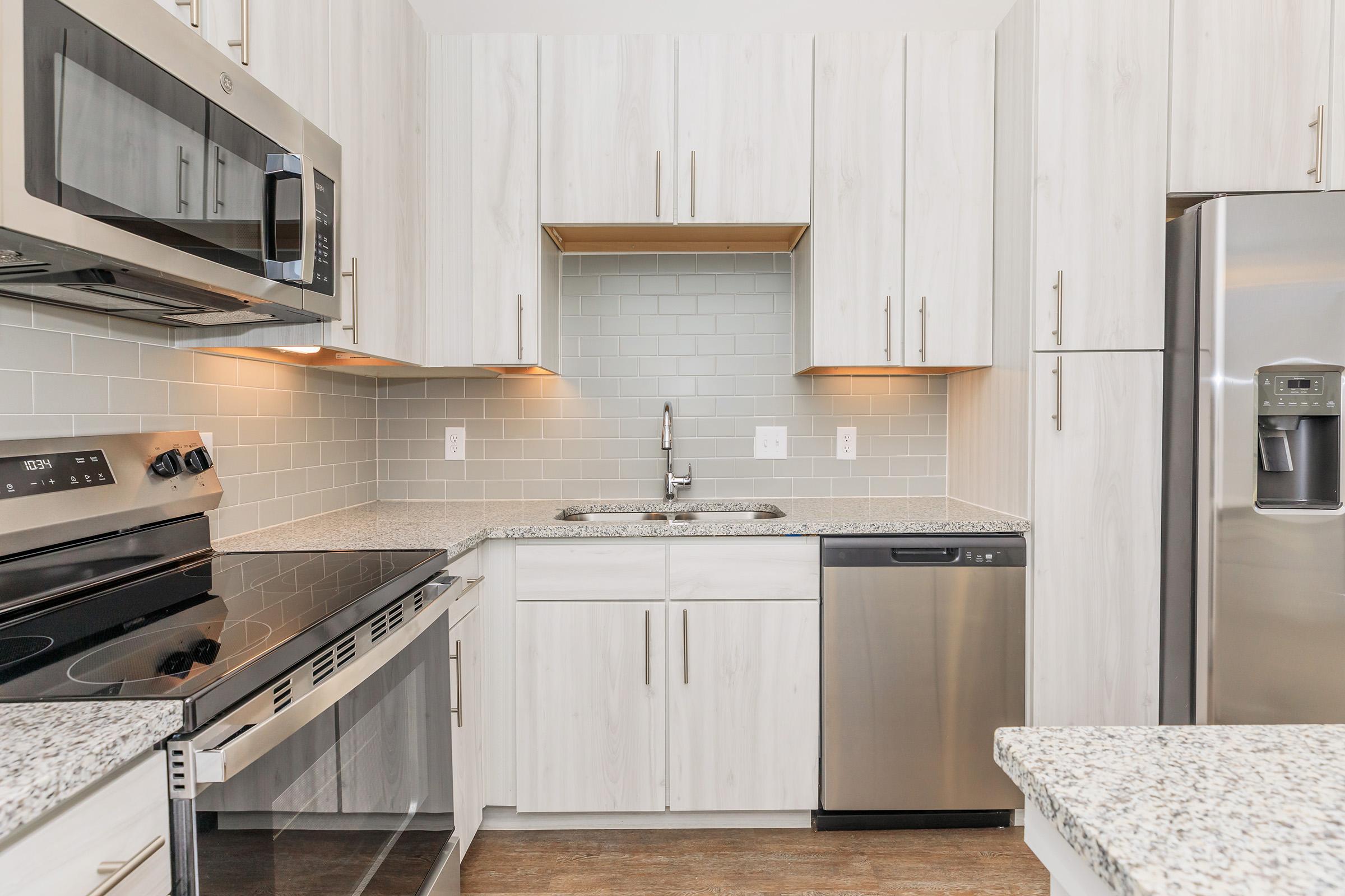 a kitchen with a stove top oven