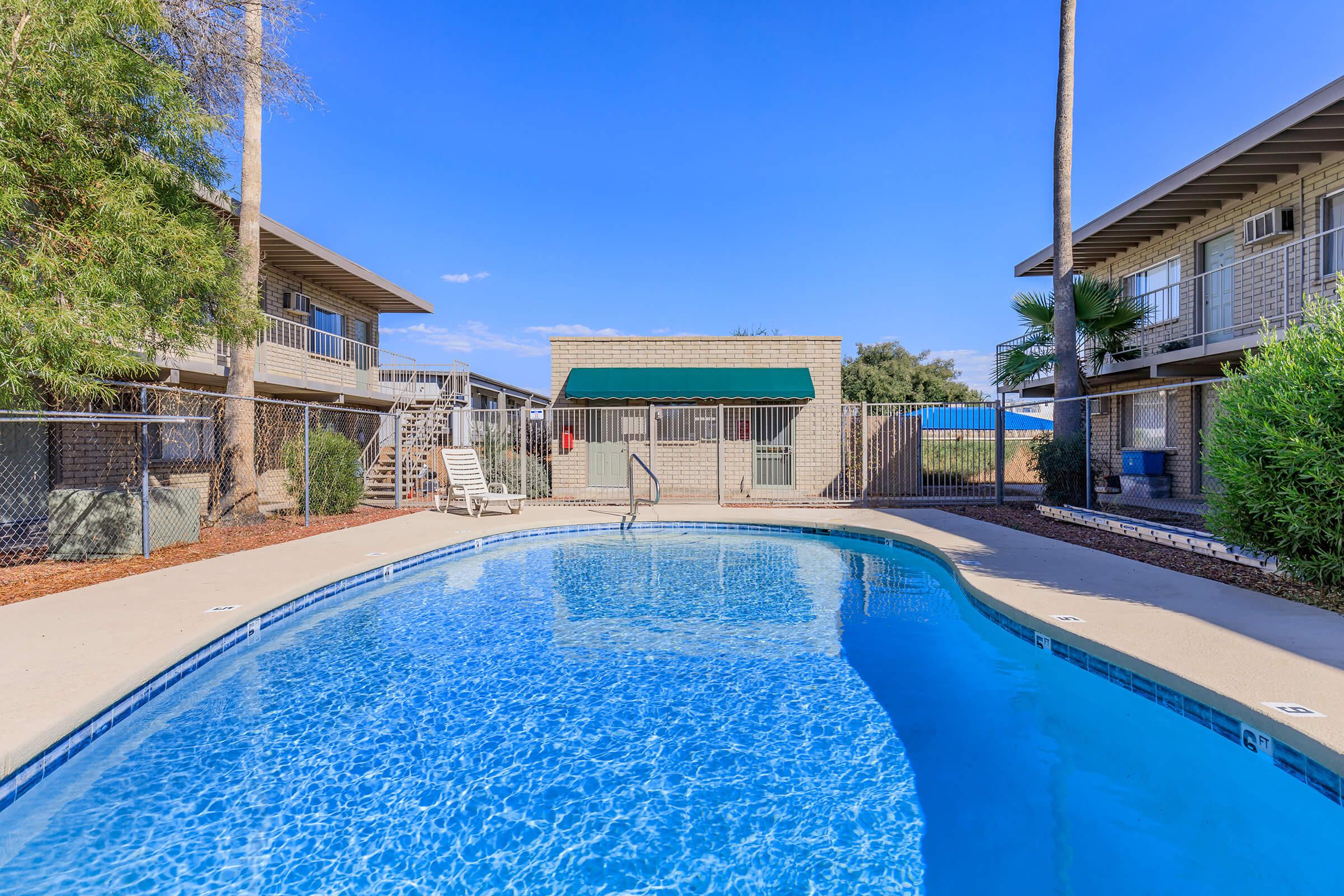 a house with a pool outside of a building