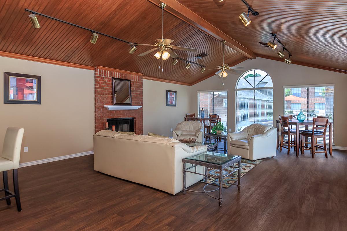 a living room filled with furniture on top of a hard wood floor