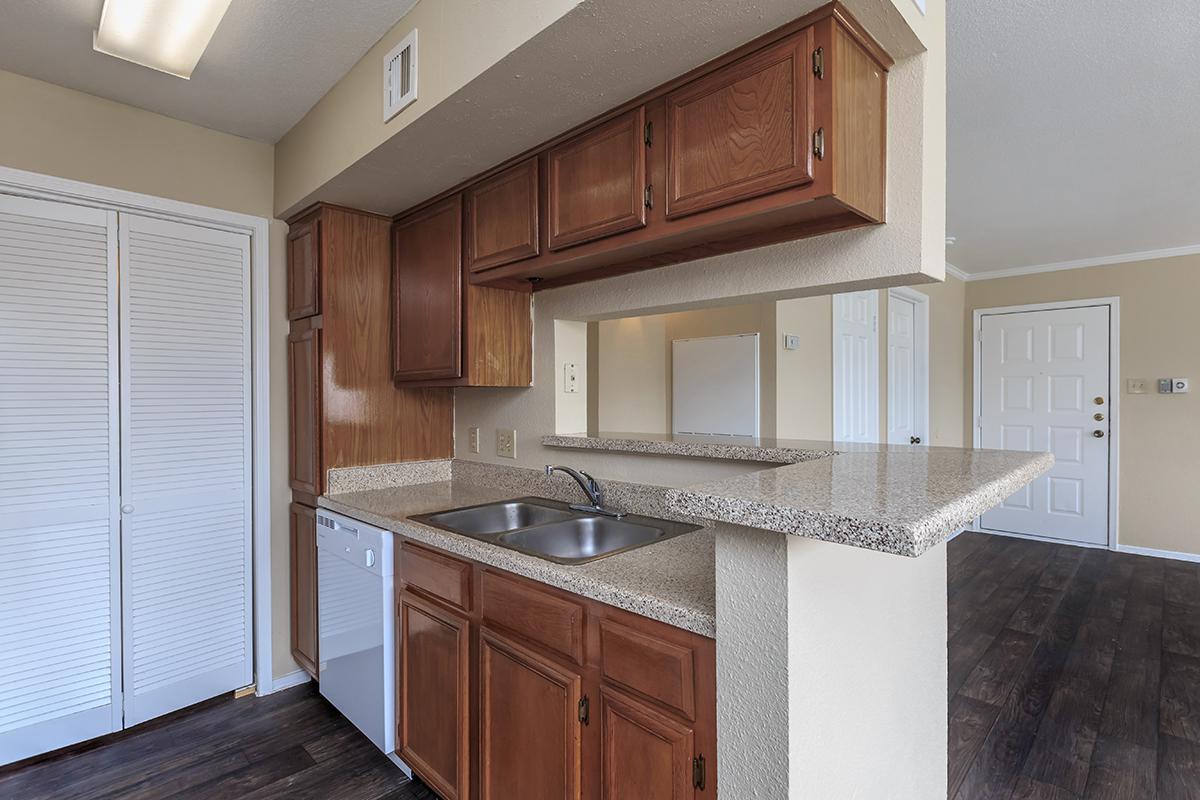 a kitchen with stainless steel appliances and wooden cabinets