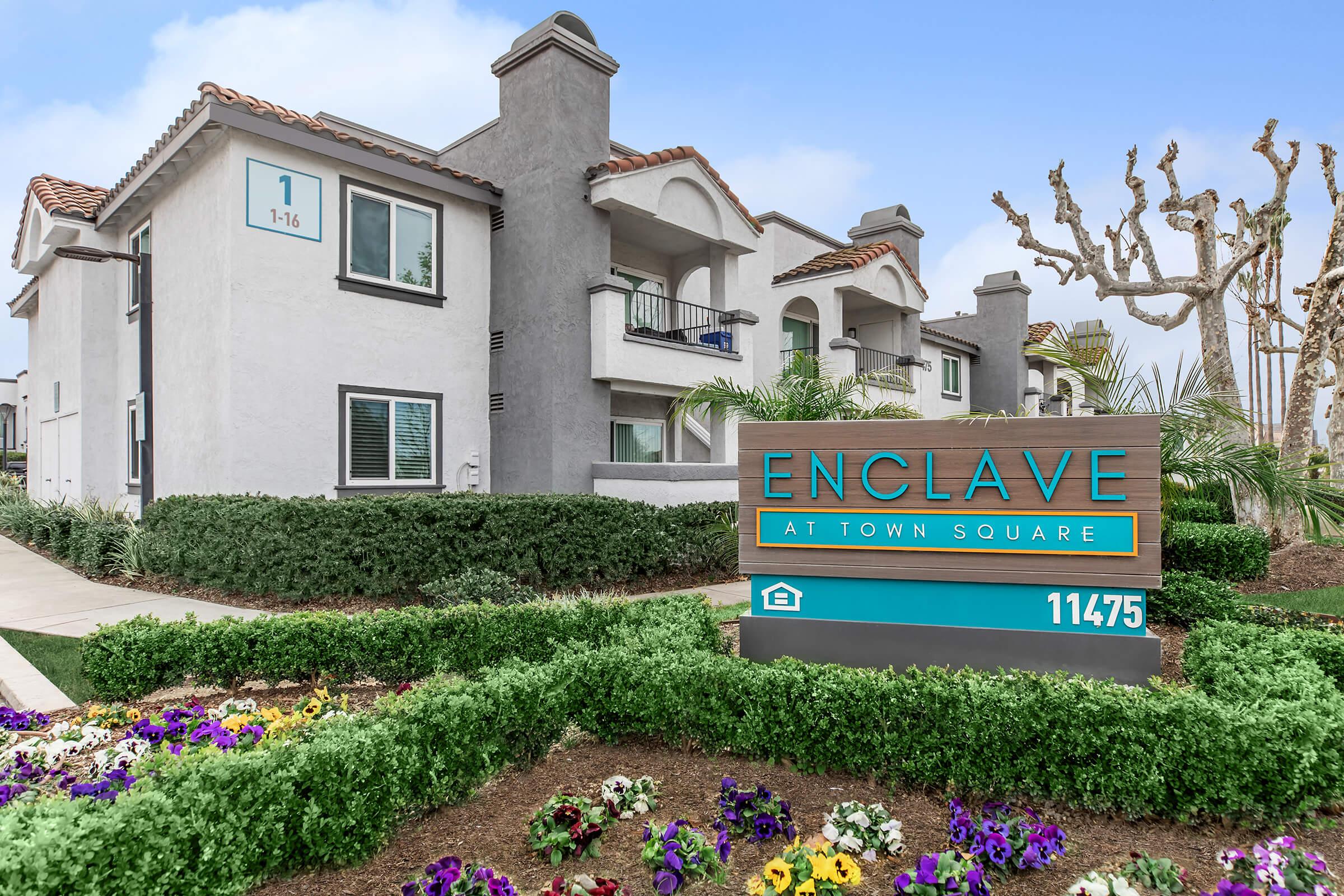 a colorful flower garden in front of a house