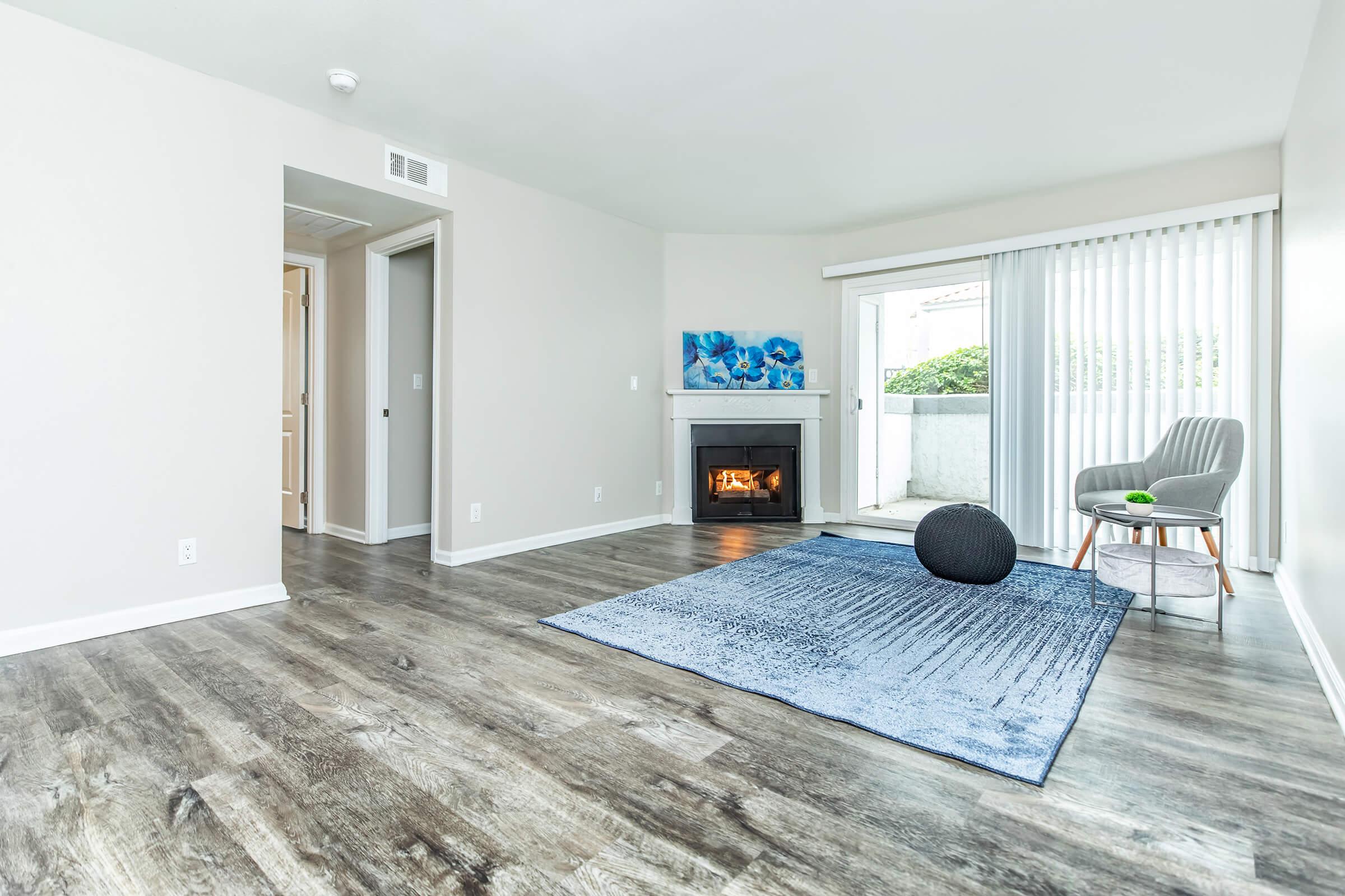 a living room filled with furniture and a large window