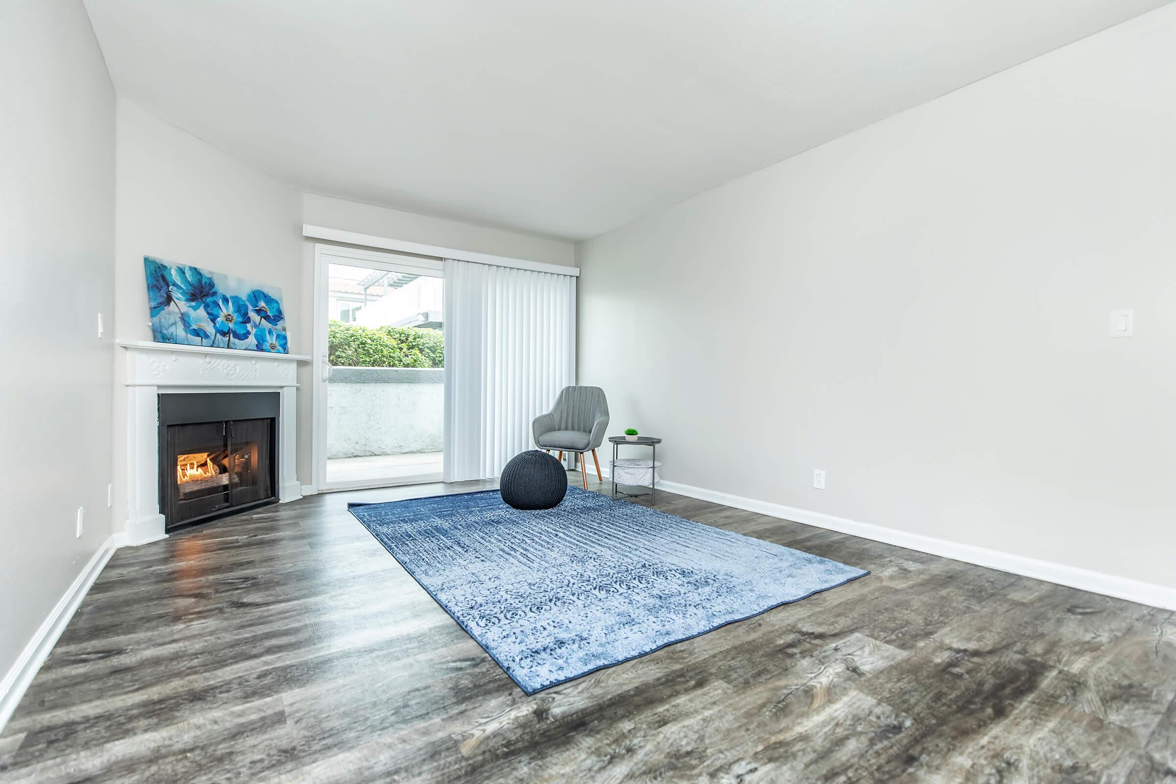 a living room filled with furniture and a large window