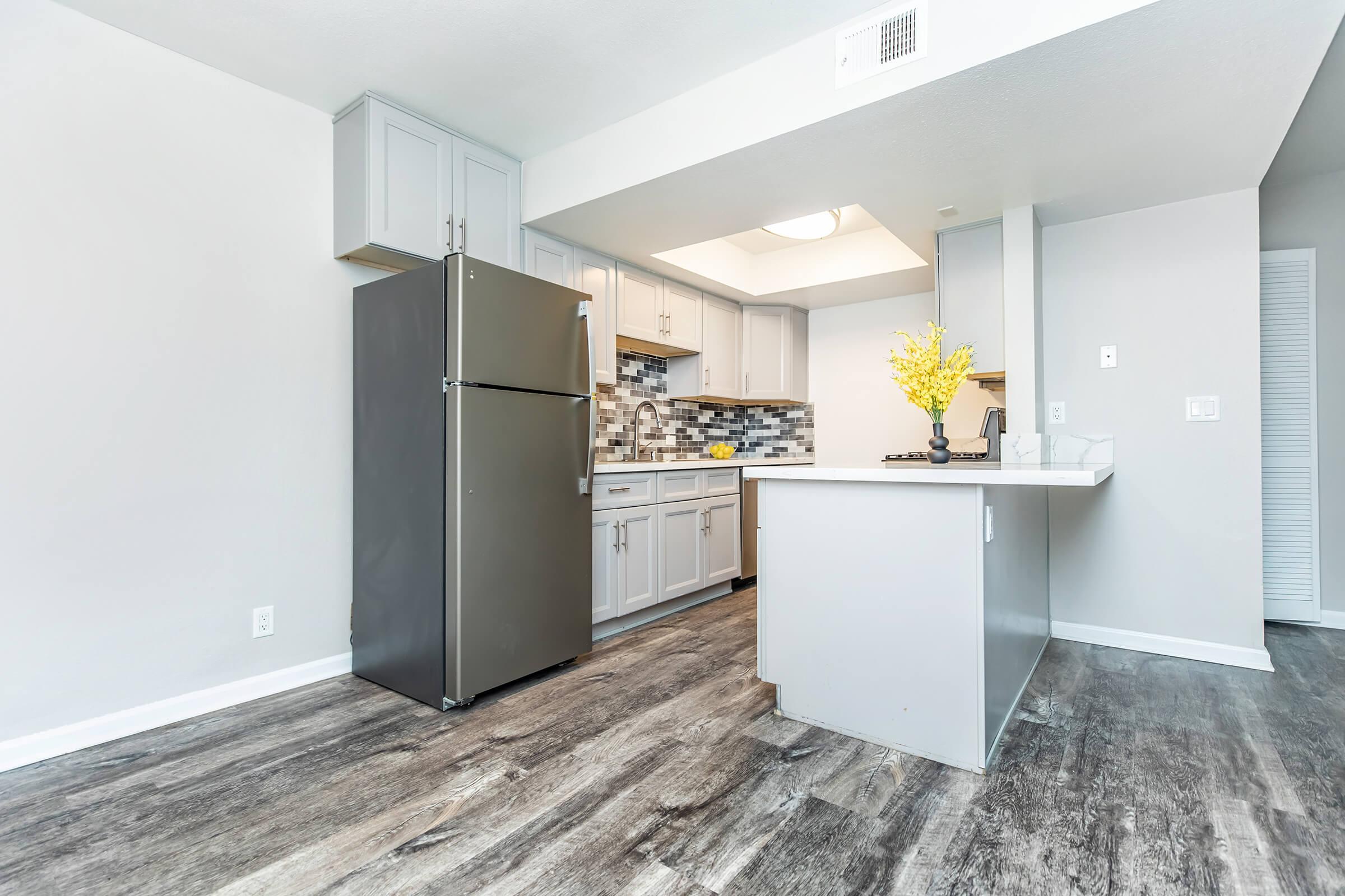 a kitchen area with a building in the background