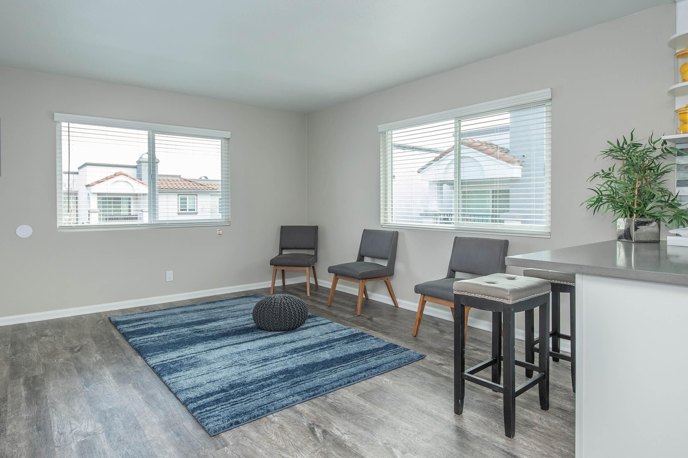 a living room filled with furniture and a large window