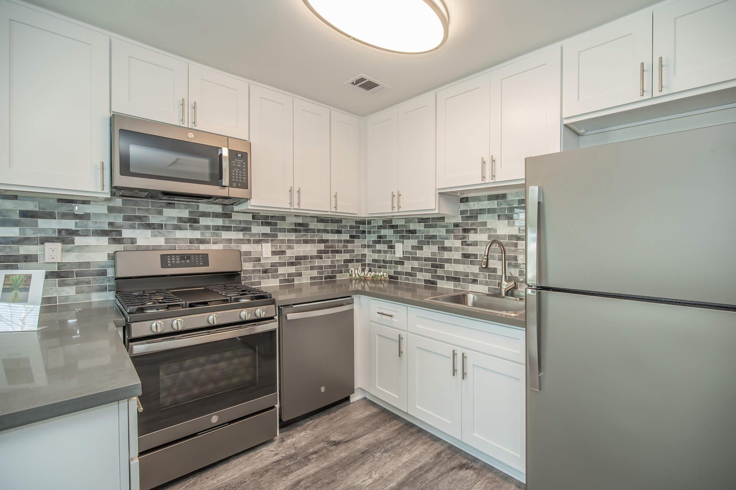 a kitchen with a stove and a refrigerator