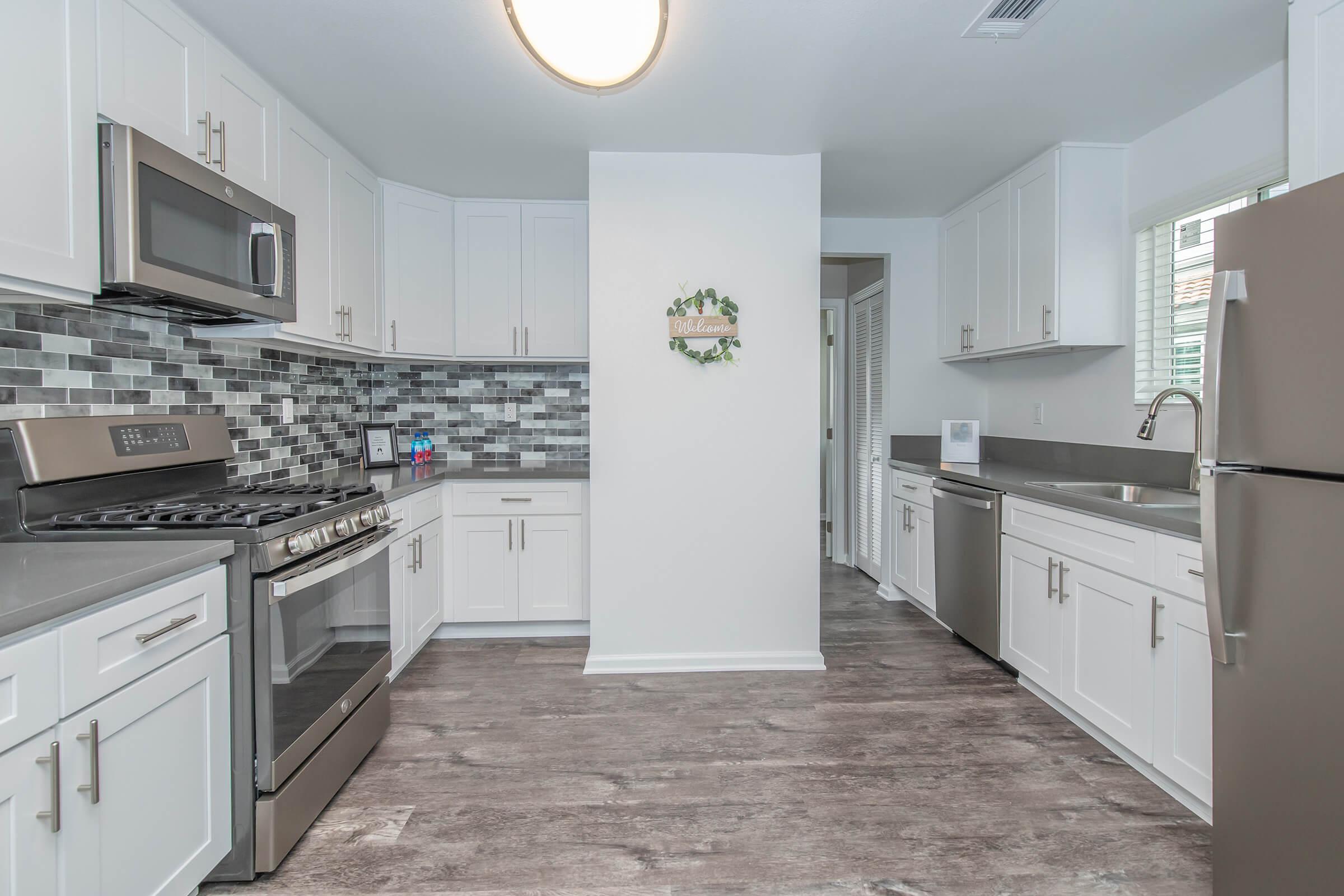 a kitchen with a stove sink and refrigerator