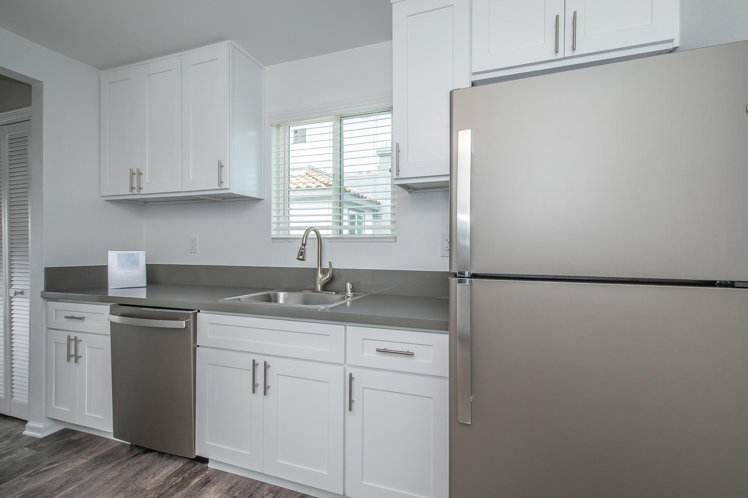 a kitchen with a sink and a refrigerator