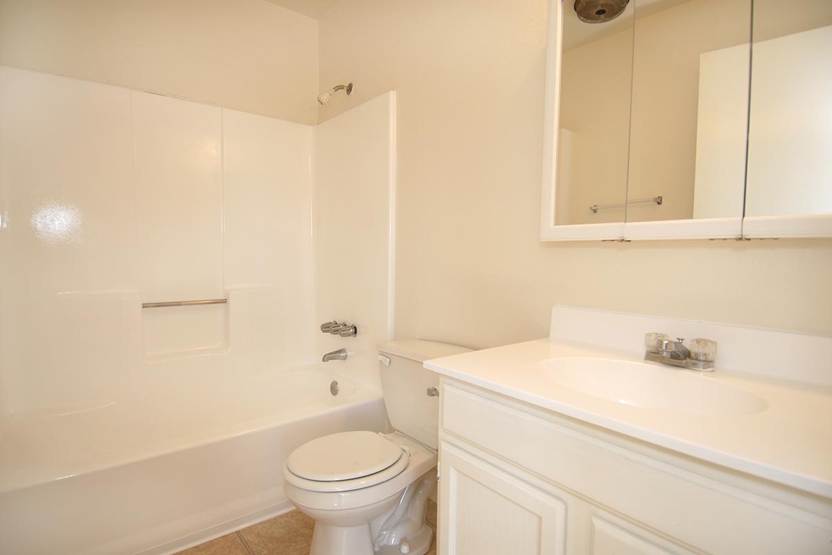 a white tub sitting next to a sink