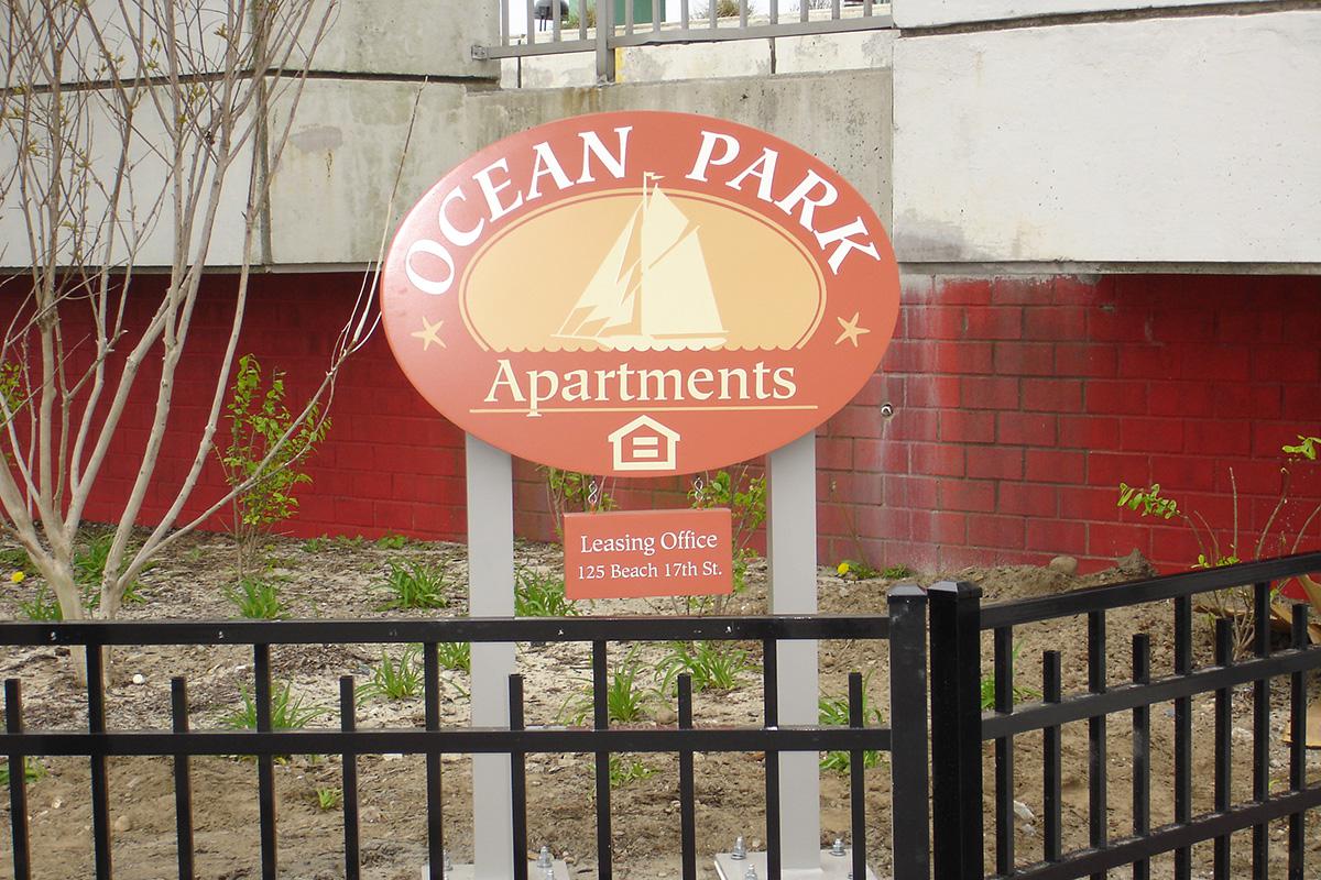 a sign in front of a fence