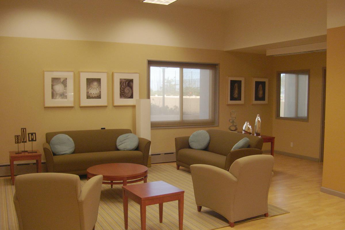 a living room filled with furniture and a large window